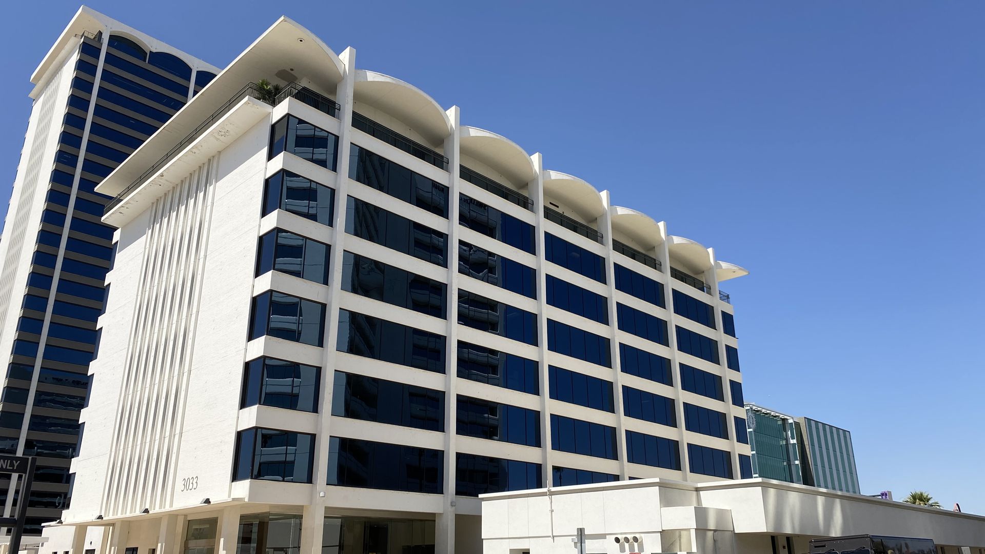 A rectangular eight story office building.