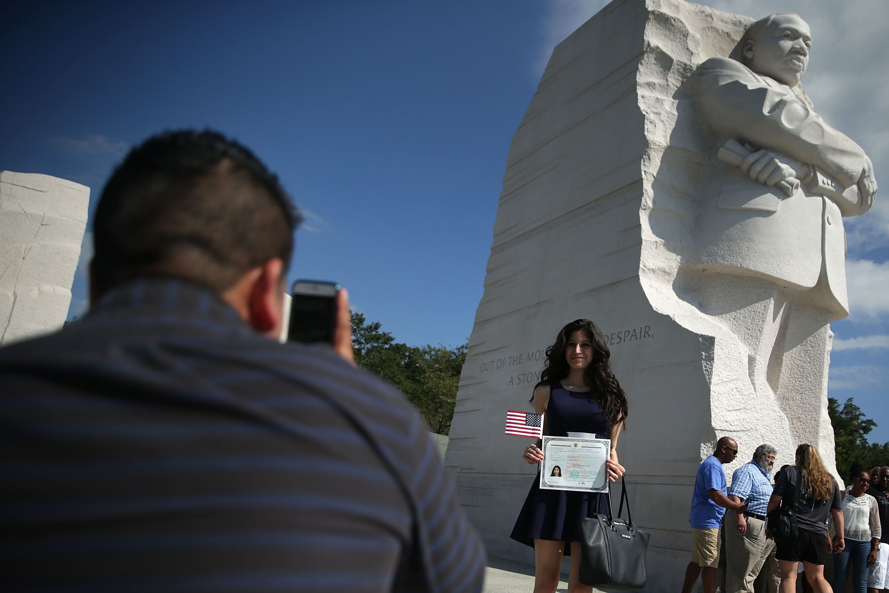 Judith Escobar of Lorton, Virginia, who was originally from El Salvador, poses with her certificate after a special naturalization ceremony at Martin Luther King, Jr. Memorial n Washington.
