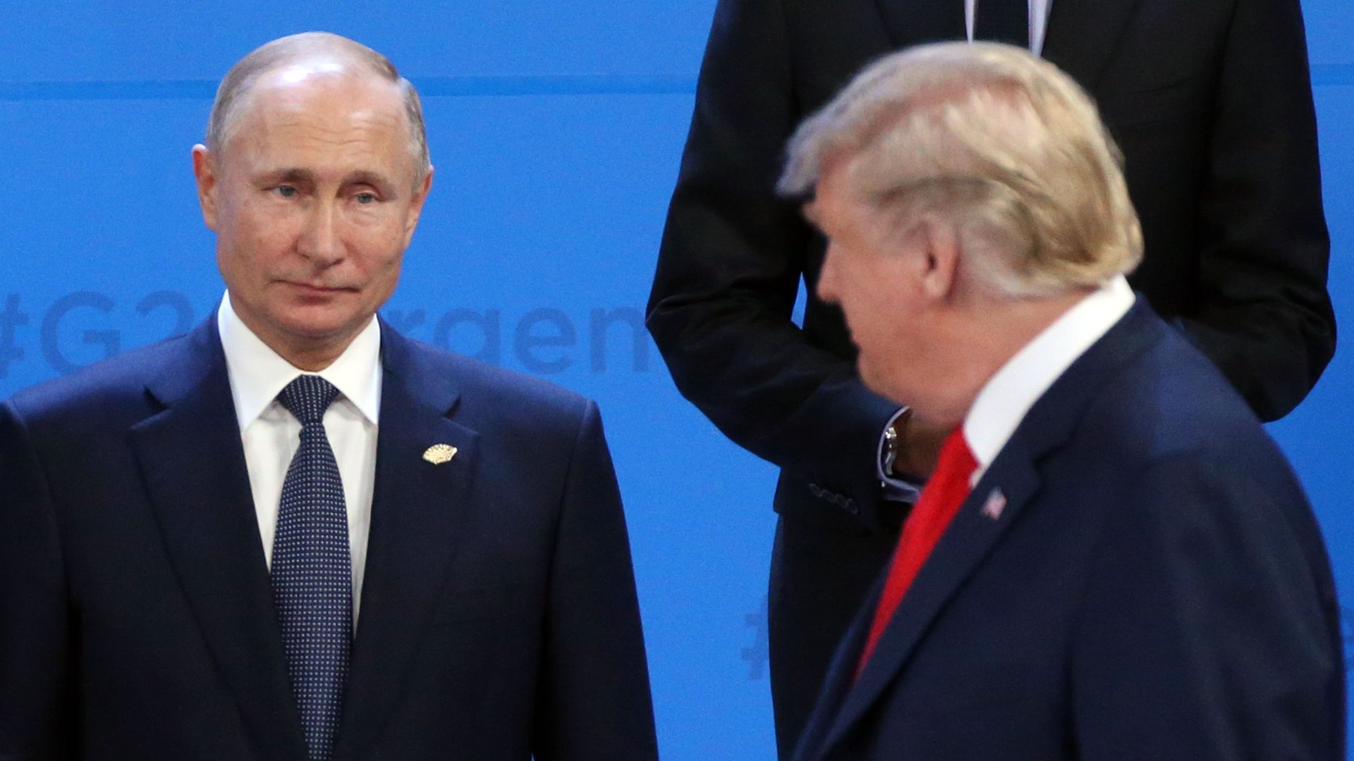 Putin on the left looks at Trump