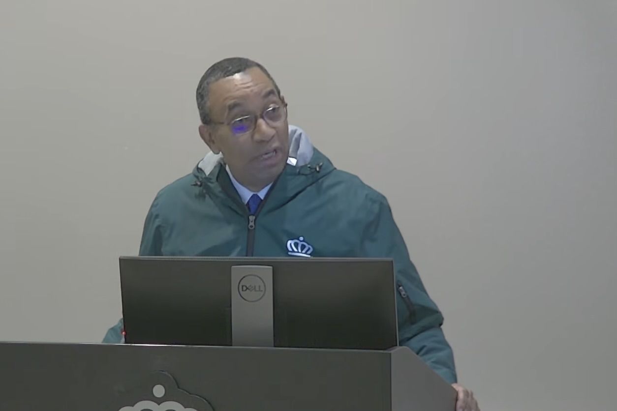 Mitchell stands at the podium