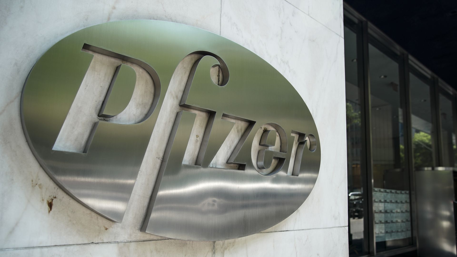 Pfizer's silver logo on a building.