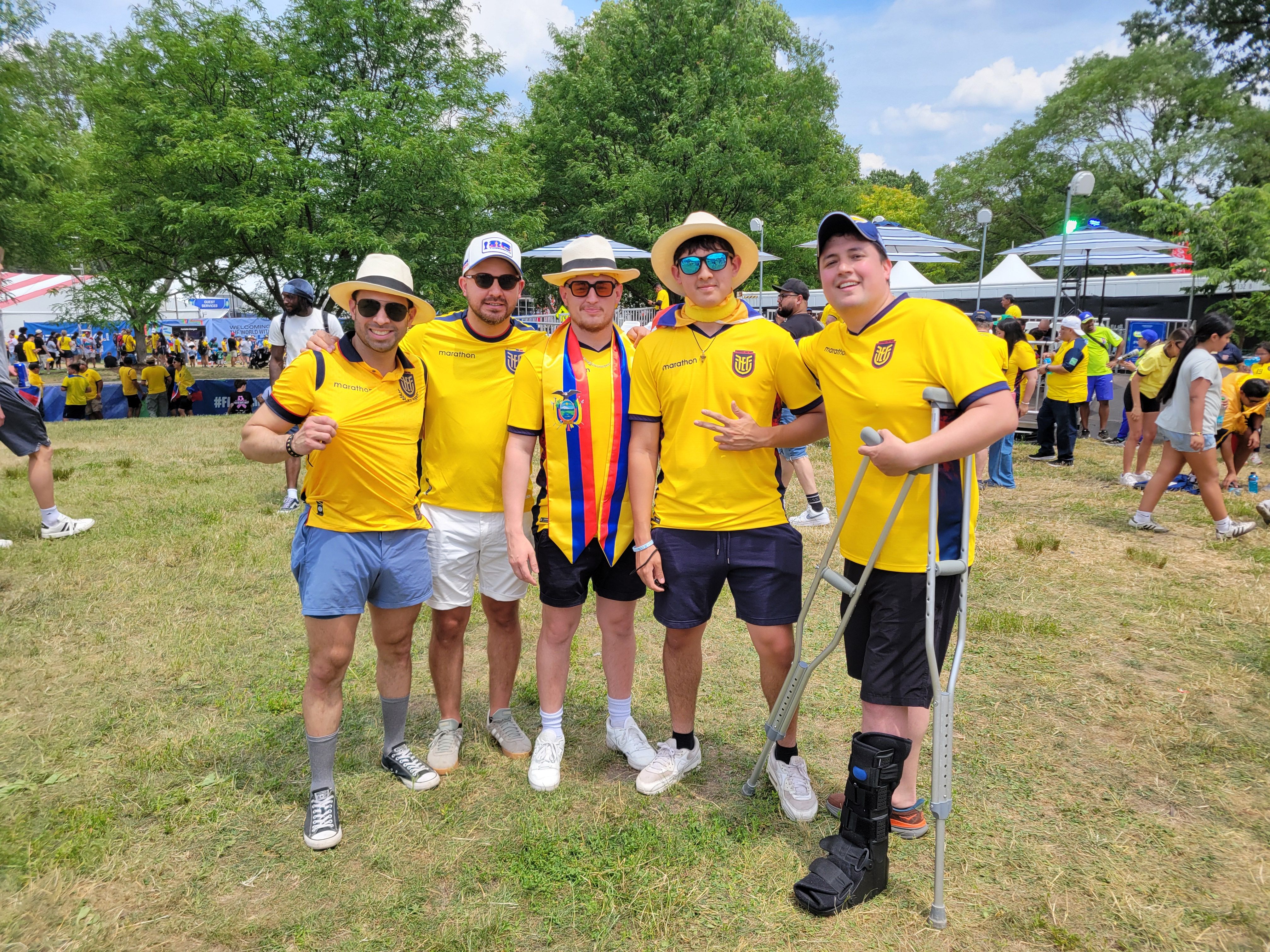 Far right: Gabriel Cobeña posing wit family and friends in yellow Ecuador jerseys at Fan Fest.