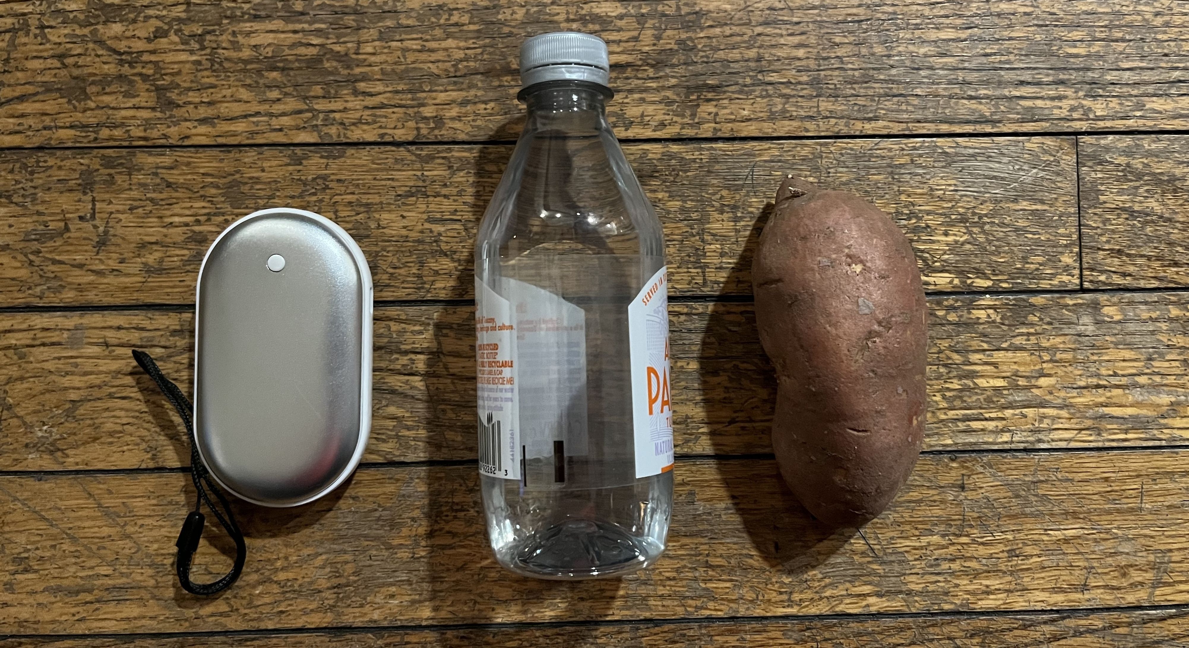 Photo of a bottle of water and a potato