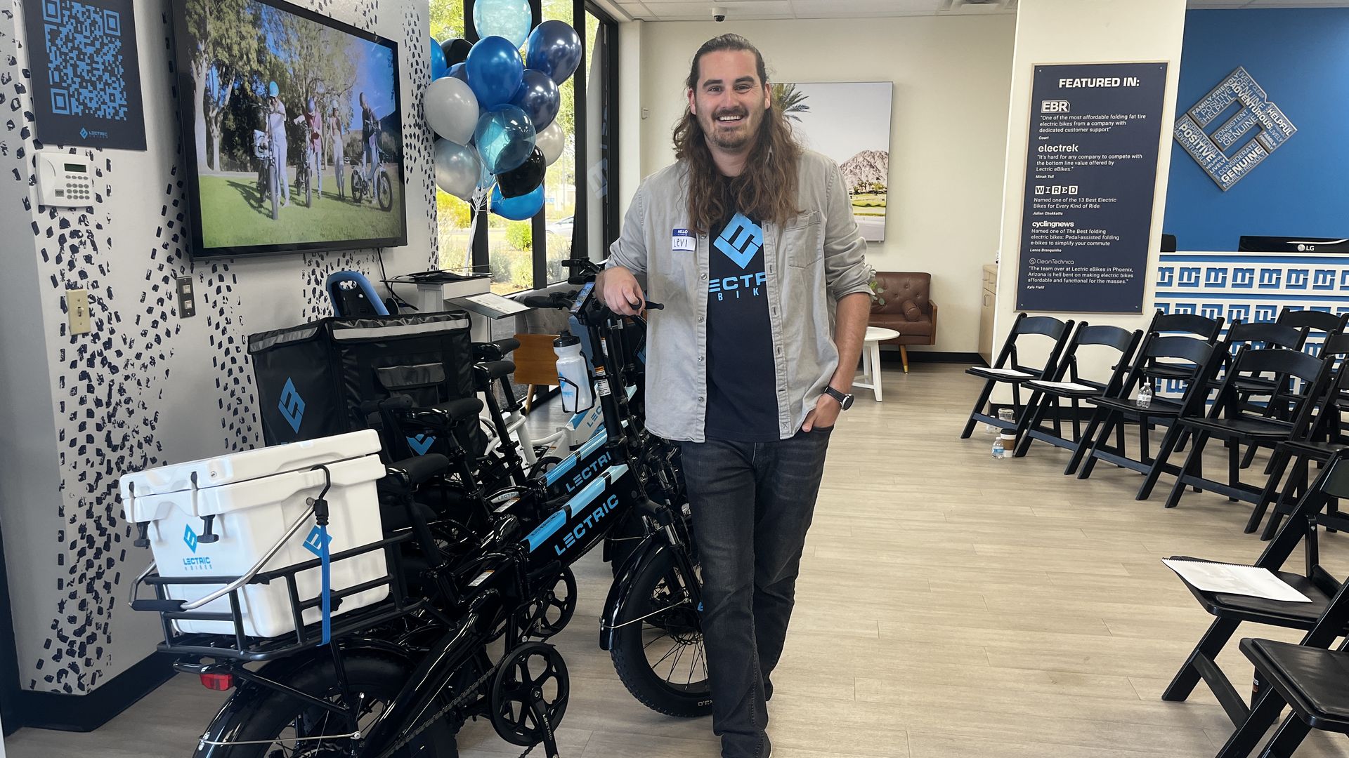A man stands next to an electric bike.