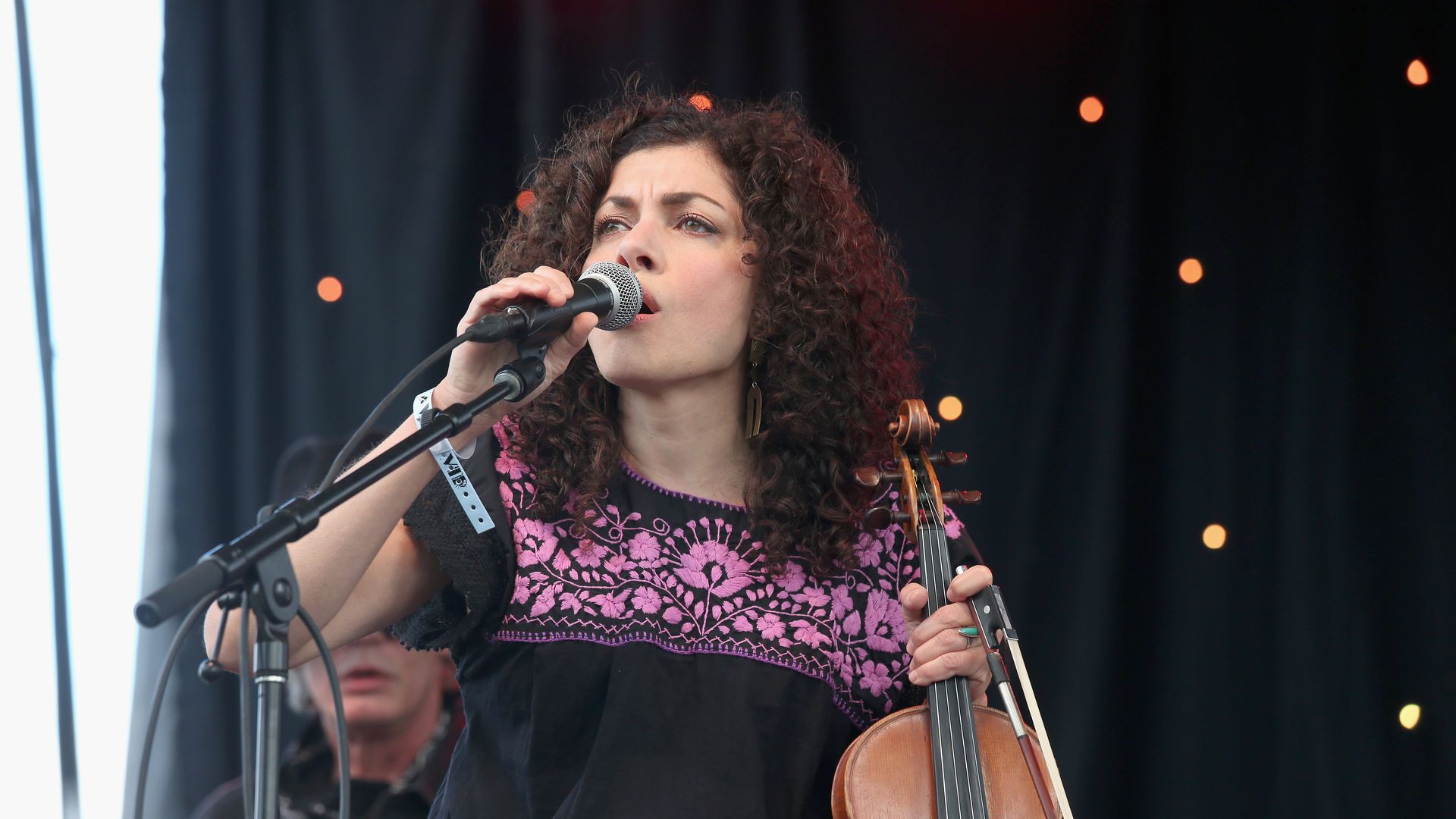 A photo of a singer holding a microphone.