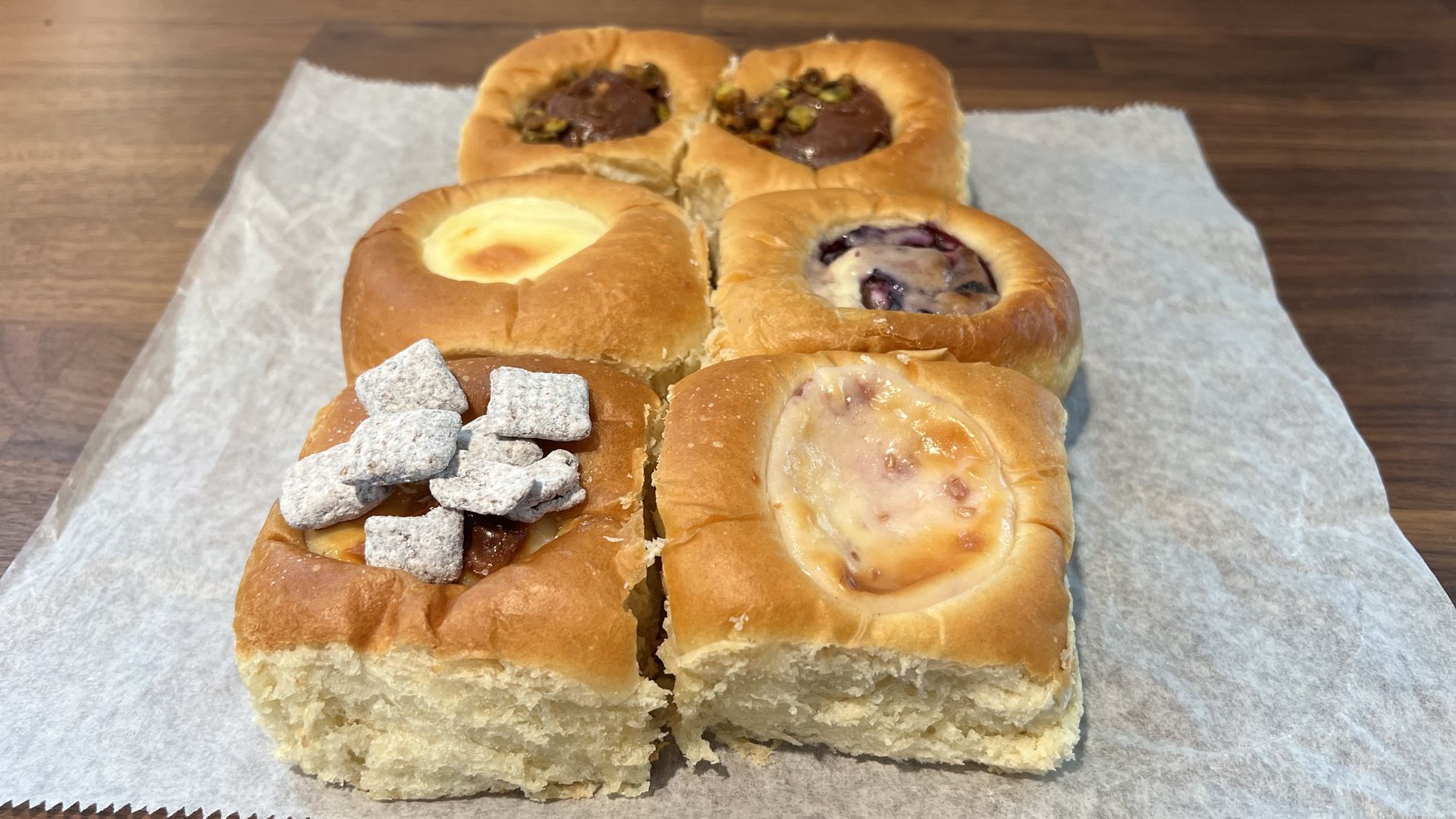 A photo of six kolache of varying flavors