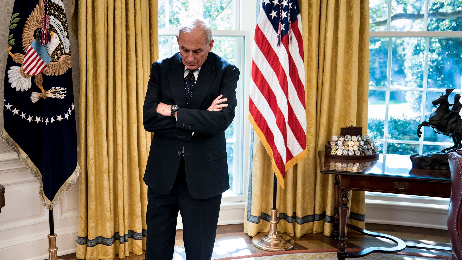 White House Chief of Staff John Kelly hangs his head while standing alone in the Oval Office of the White House 