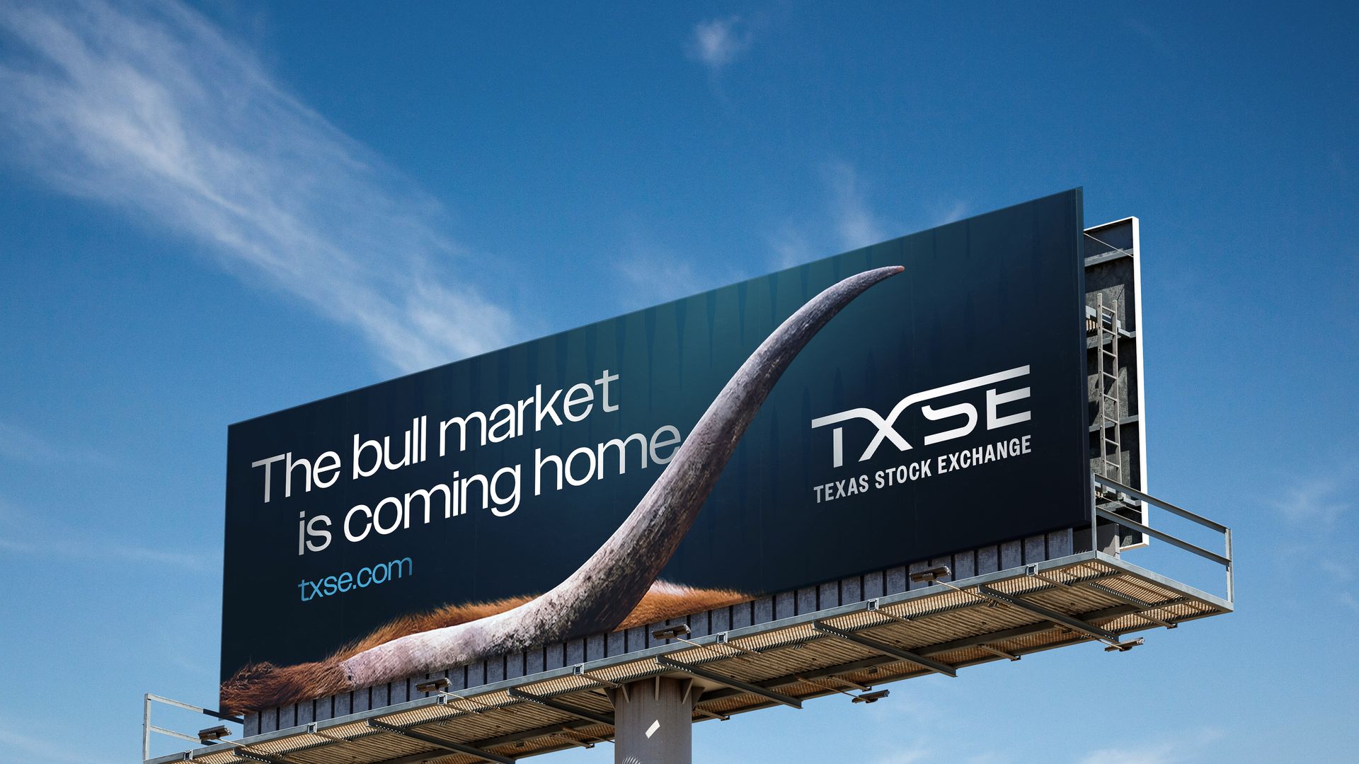 Billboard with a bull's horn and fur, text says "The bull market is coming home," promoting TXSE Texas Stock Exchange against a blue sky.