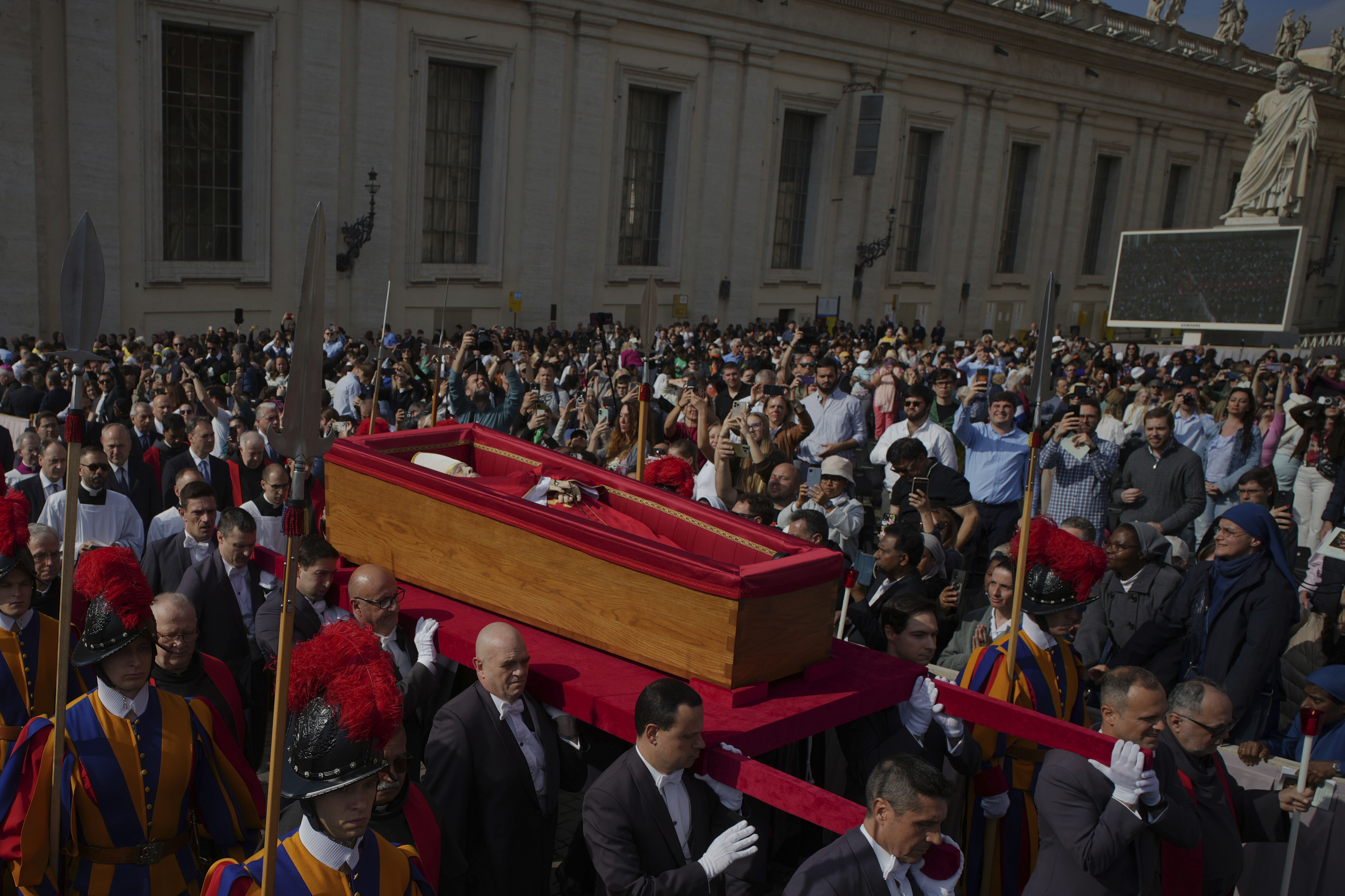 The body of Pope Francis is carried through St. Peter's Square to St. Peter's Basilica at the Vatican, Wednesday, April 23, 2025, where he will lie in state for three days. (AP Photo/Markus Schreiber)