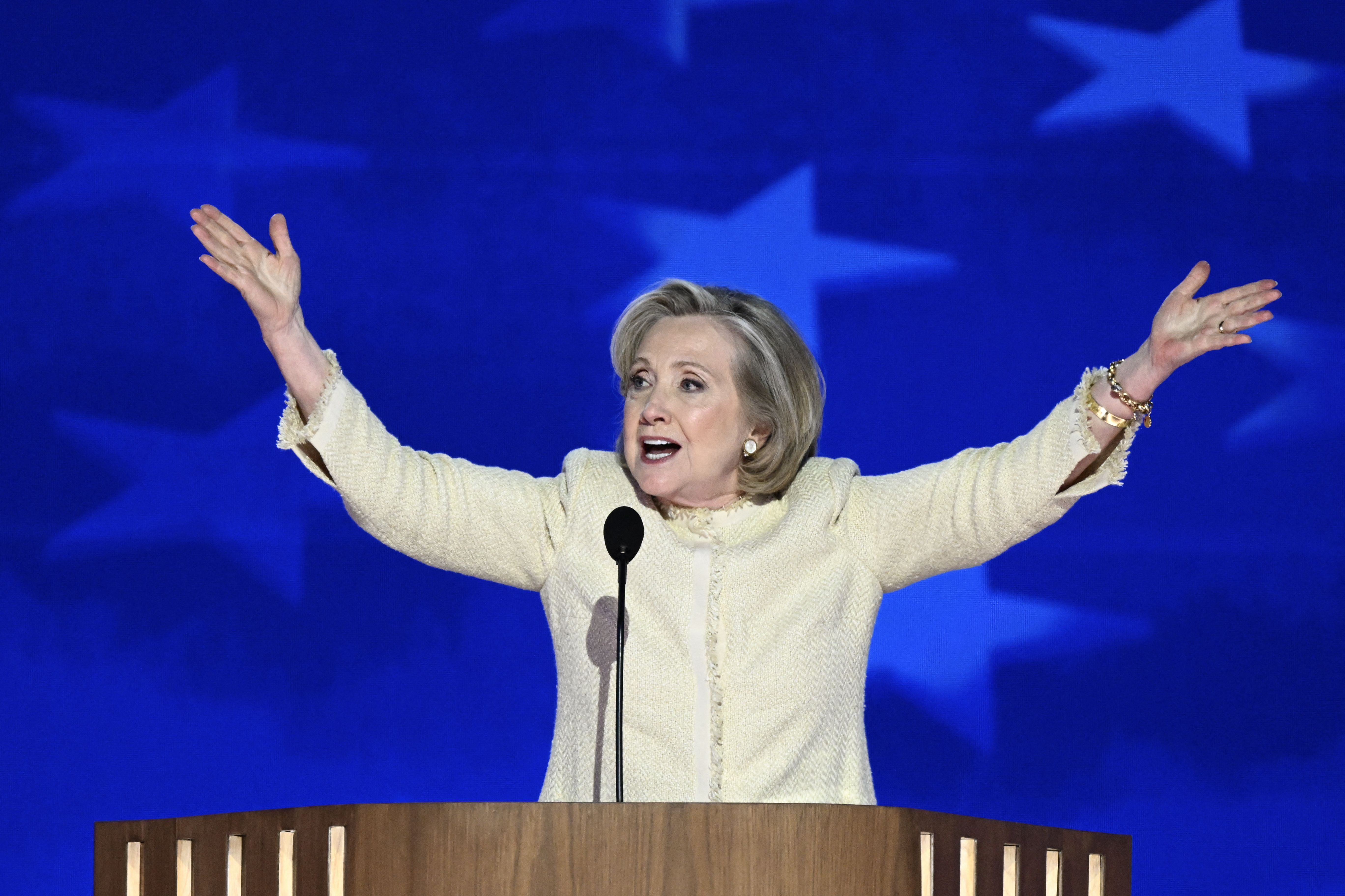 Hillary Clinton throws her arms up