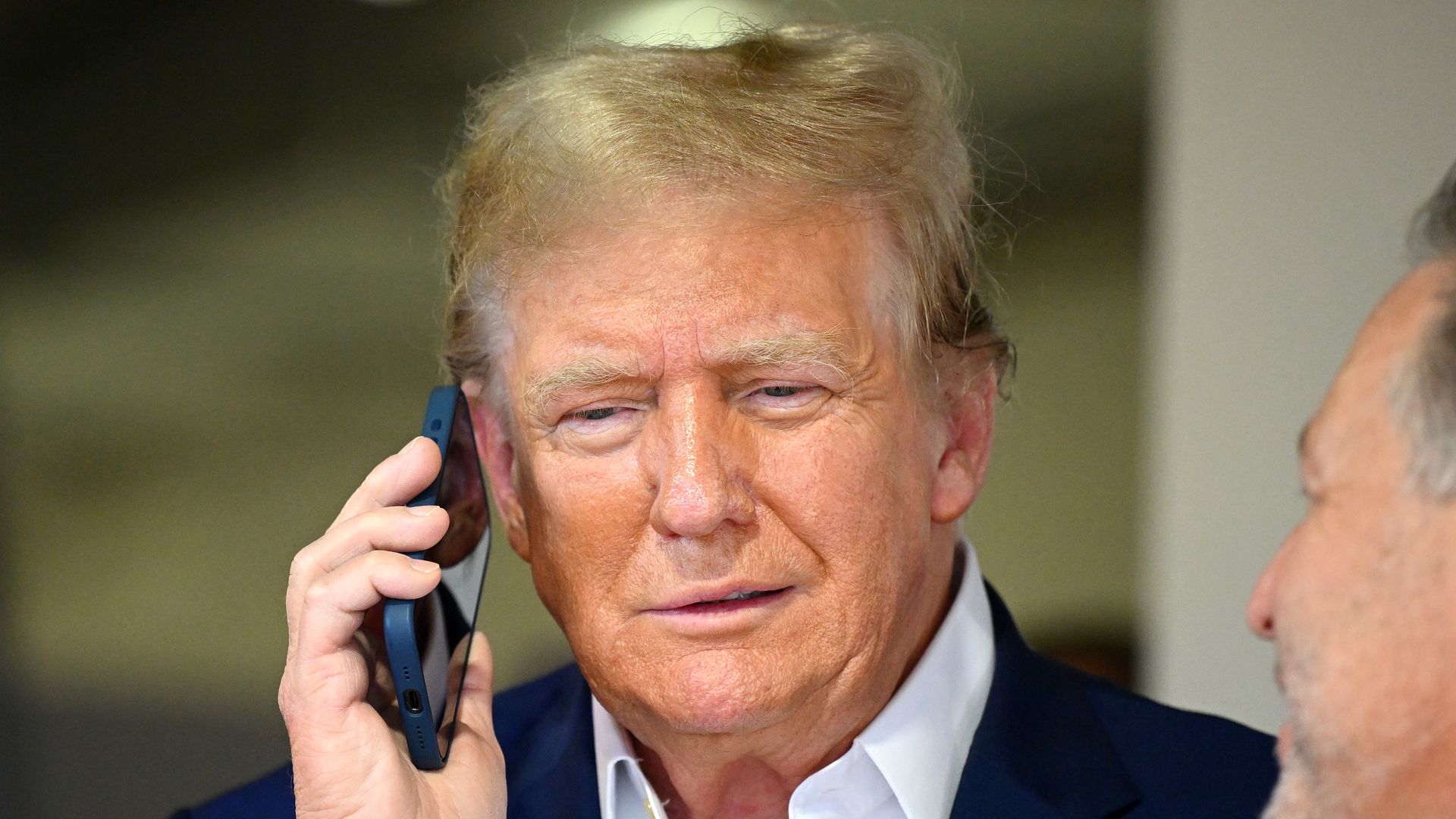 MIAMI, FLORIDA - MAY 05: Donald Trump talks on the phone in the McLaren garage prior to the F1 Grand Prix of Miami at Miami International Autodrome on May 05, 2024 in Miami, Florida.