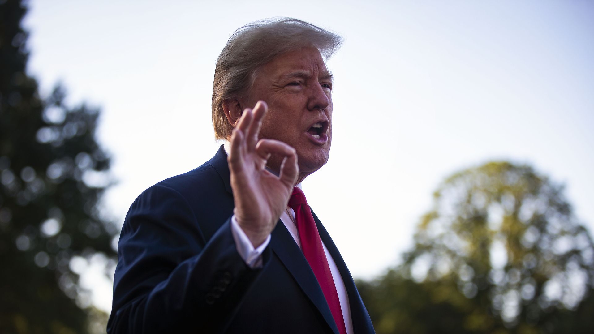 Donald Trump with fingers in air talking.