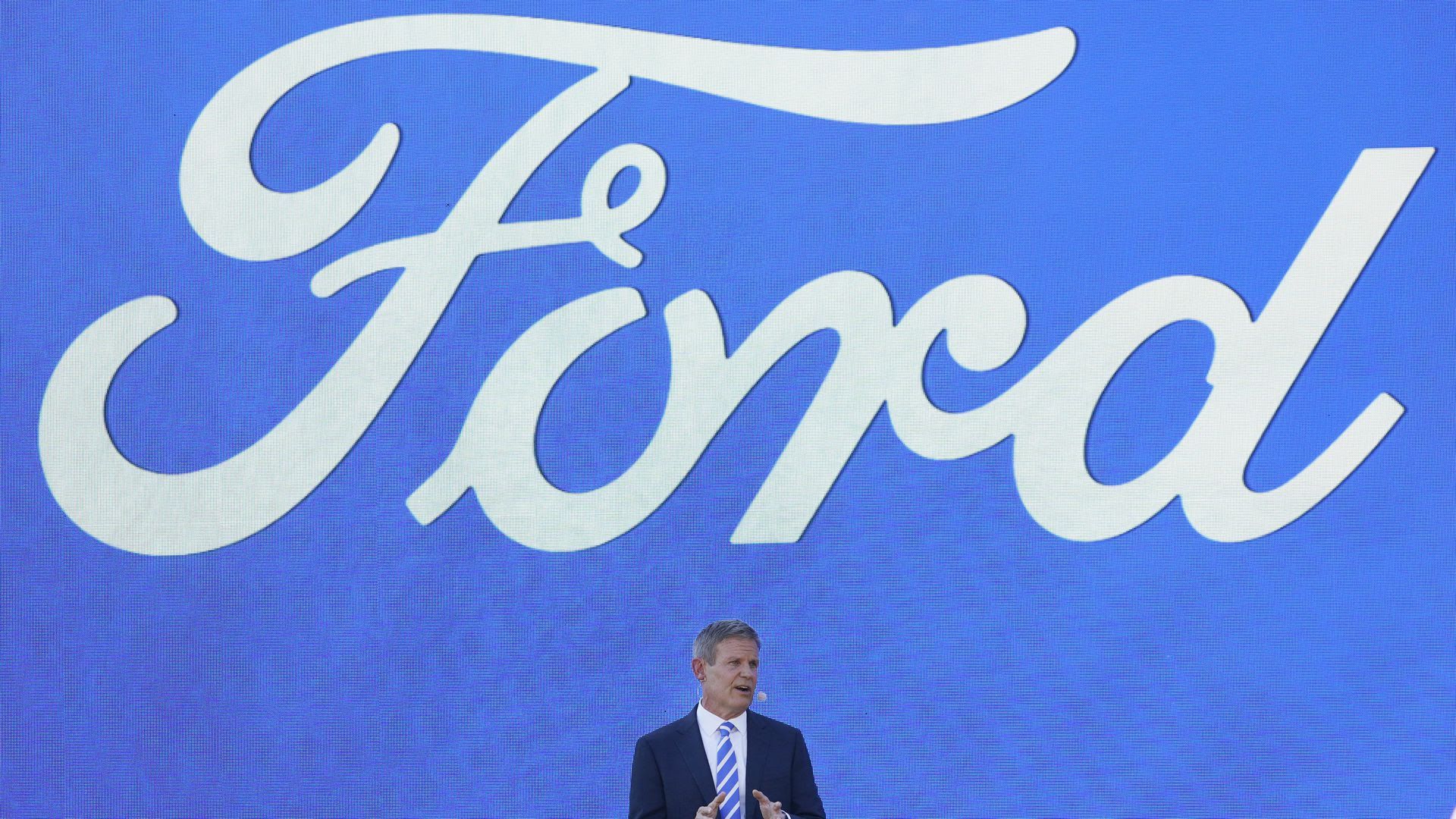 Gov. Bill Lee speaks at the announcement of a new Ford plant in West Tennessee in front of a giant Ford sign.