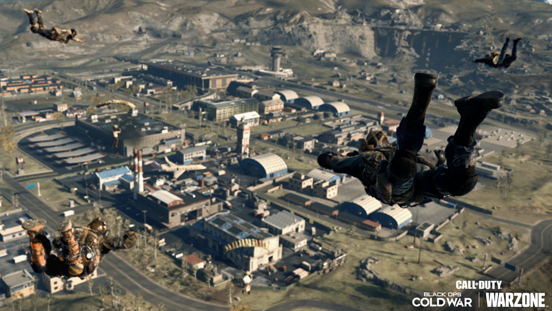 Video game screenshot of soldiers parachuting down to a city