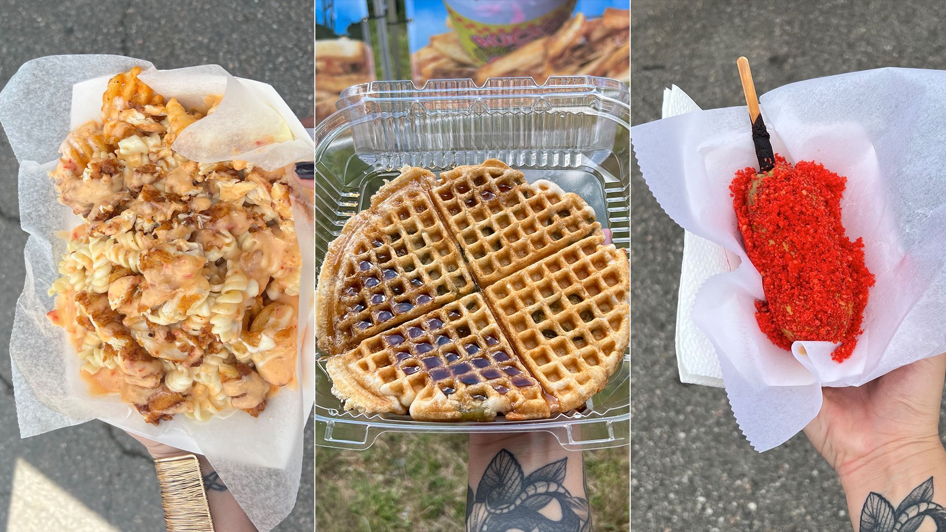 Three food items held by a tattooed hand: creamy sauced pasta with chicken, syrup-covered waffle in a plastic container, and a corn dog covered in bright red crumbs on white paper.