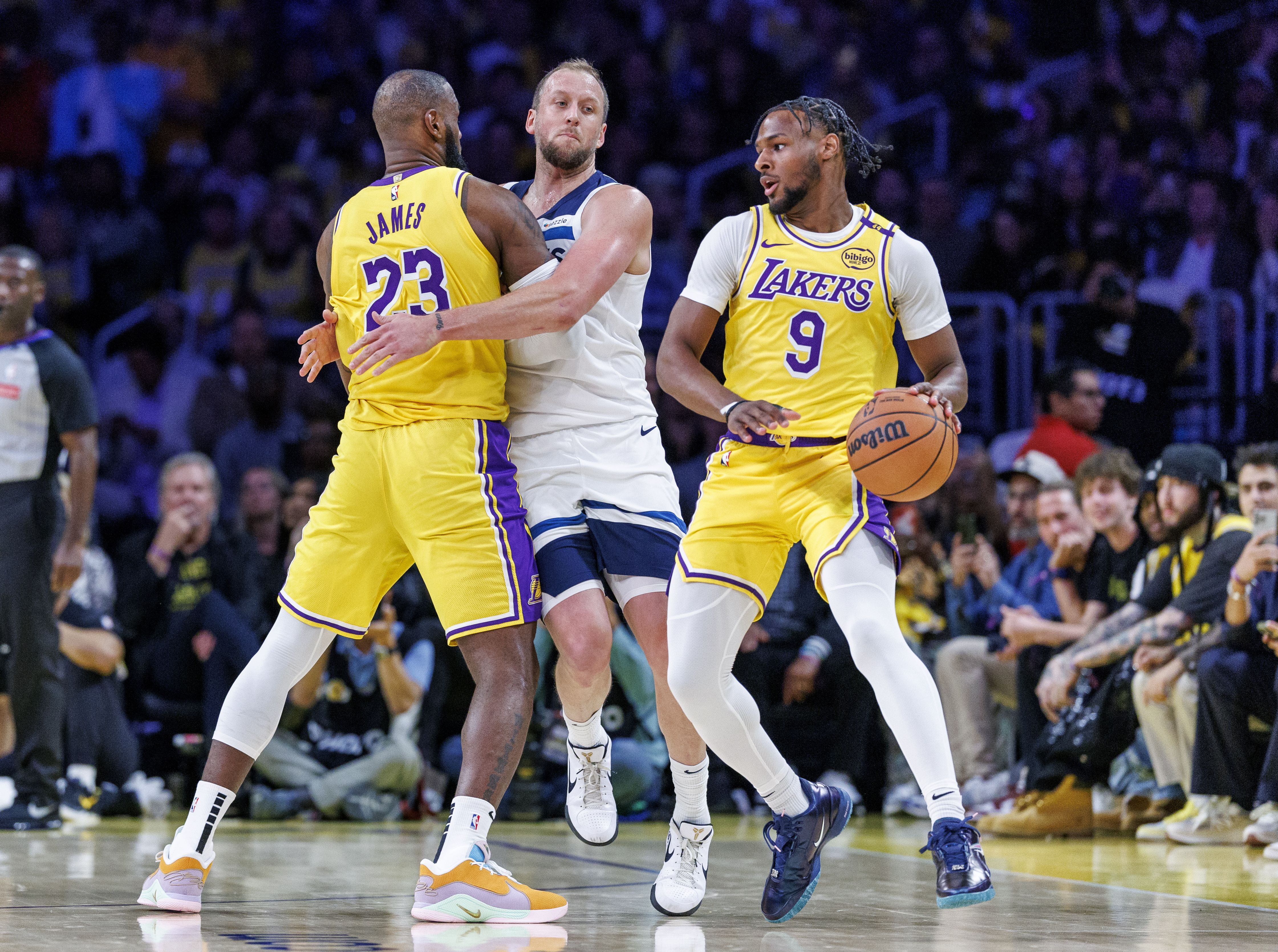Los Angeles Lakers forward LeBron James (23) sets a screen on Minnesota Timberwolves guard Joe Ingles (7) after passing to his son Los Angeles Lakers guard Bronny James (9) in the first half at Crypto.com Arena on October 22, 2024 in Los Angeles, California.