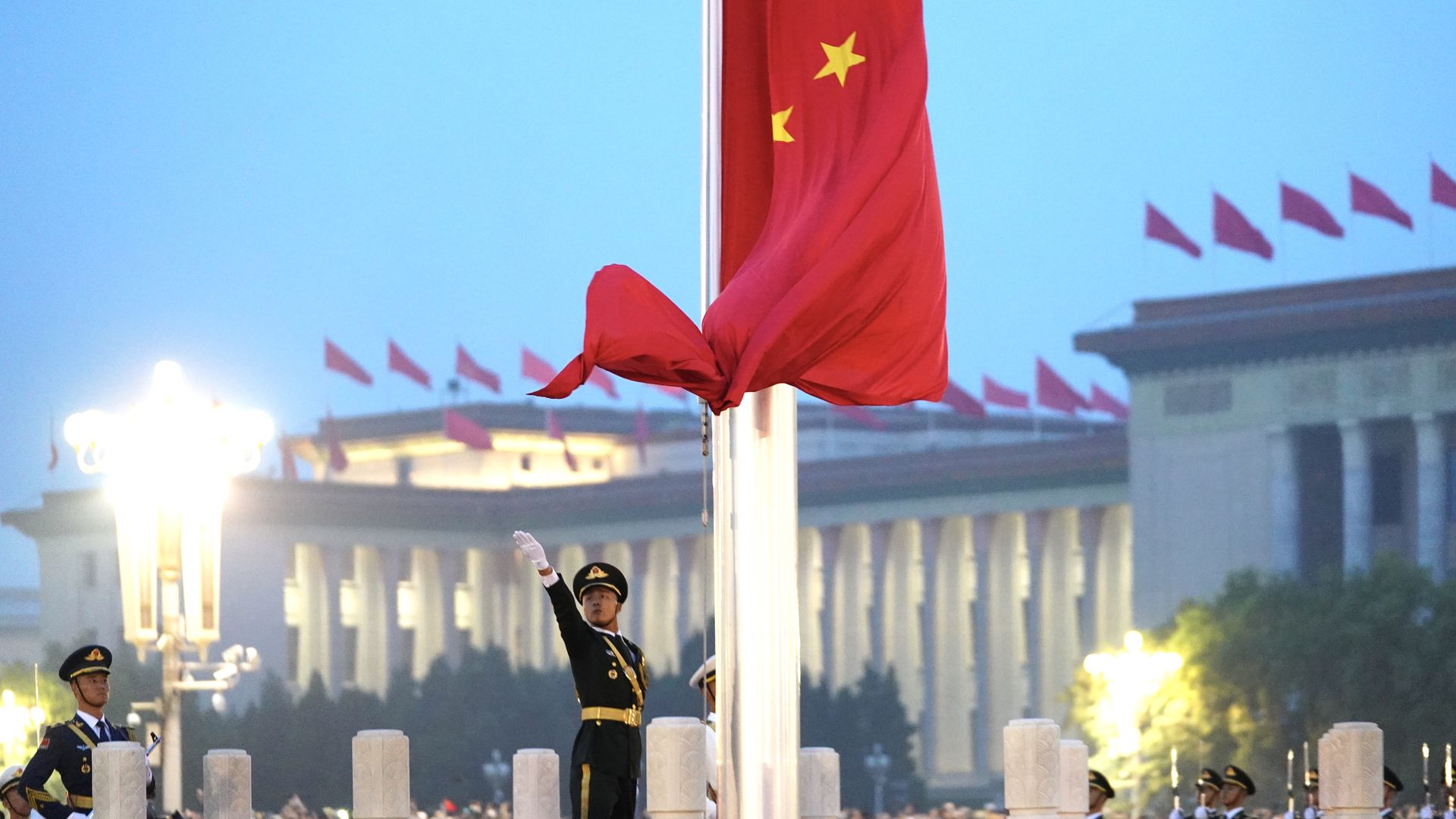 Soldiers of the People's Liberation Army (PLA) honor guard perform the flag-raising ceremony at Tiananmen Square