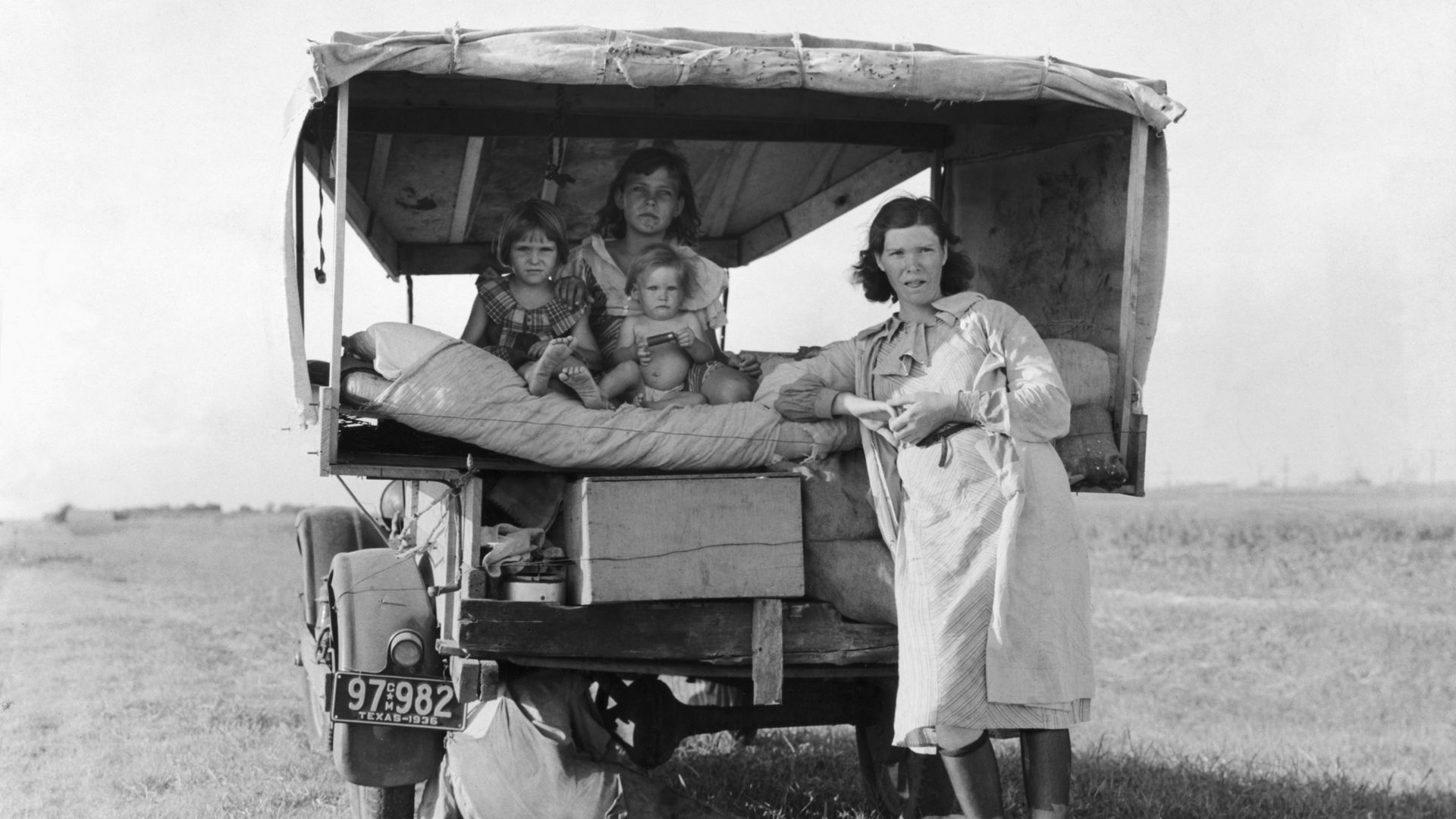 A black and white photo of a family in a carriage