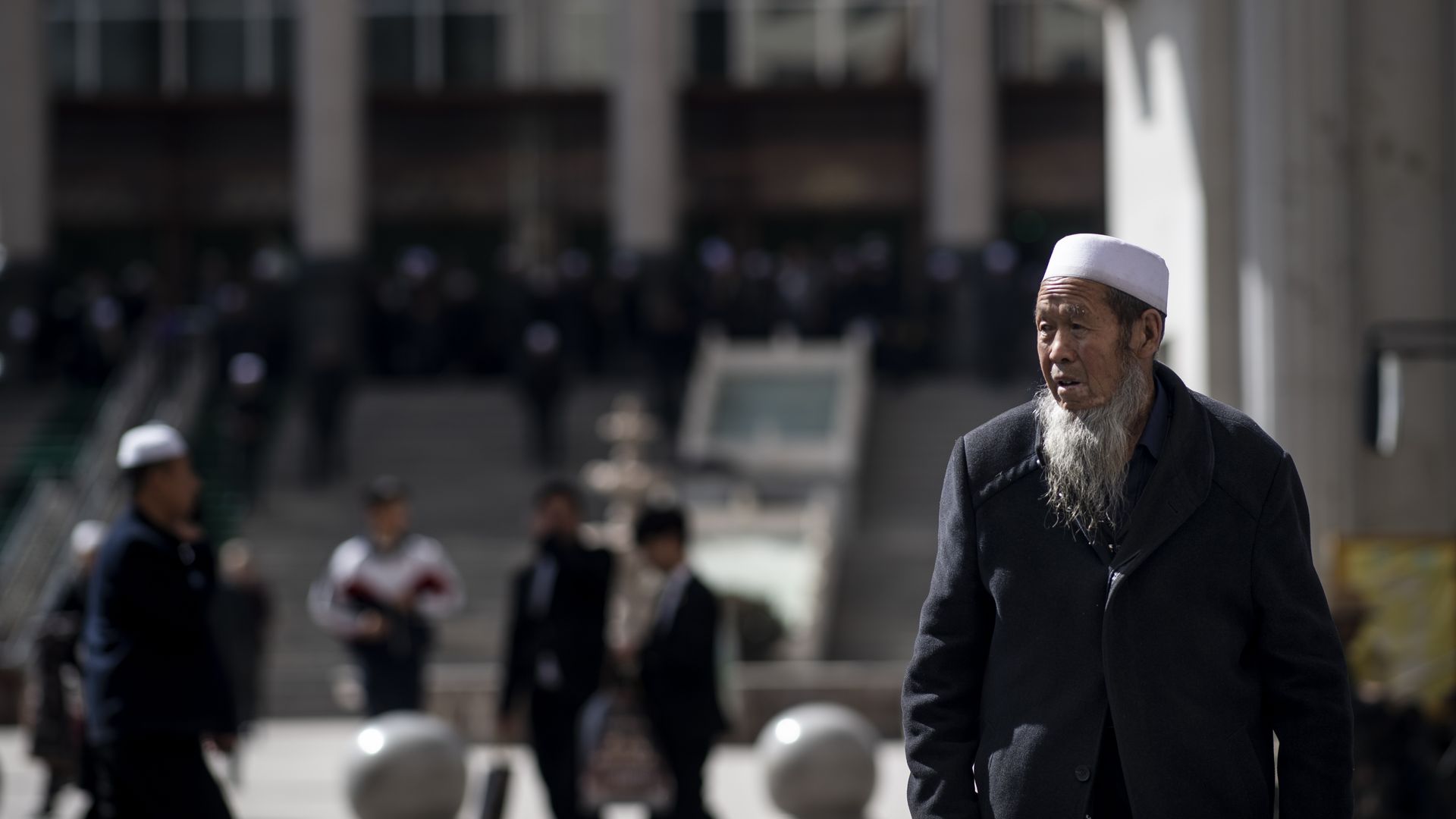 Ethnic Hui Muslim man standing in front of Laohuasi Mosque