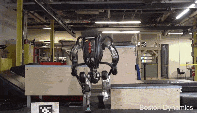 A humanoid robot bounds up a set of blocks