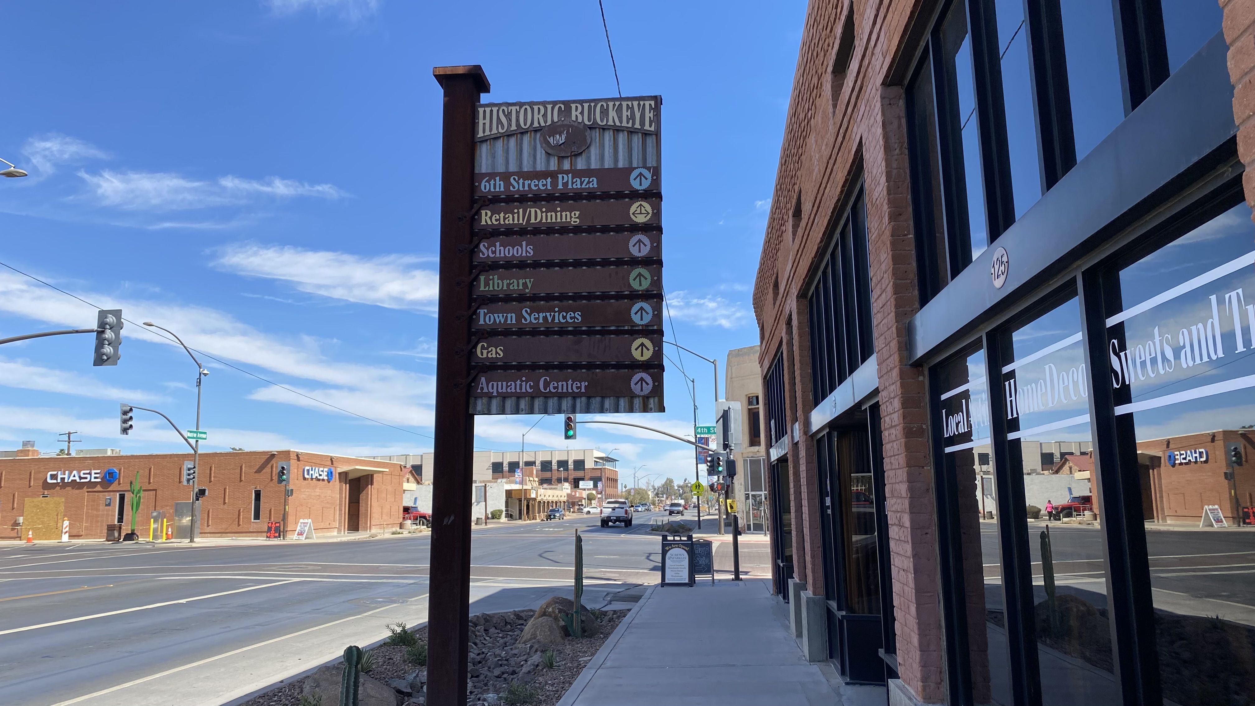 A street sign with directors to various places in historic downtown Buckeye.