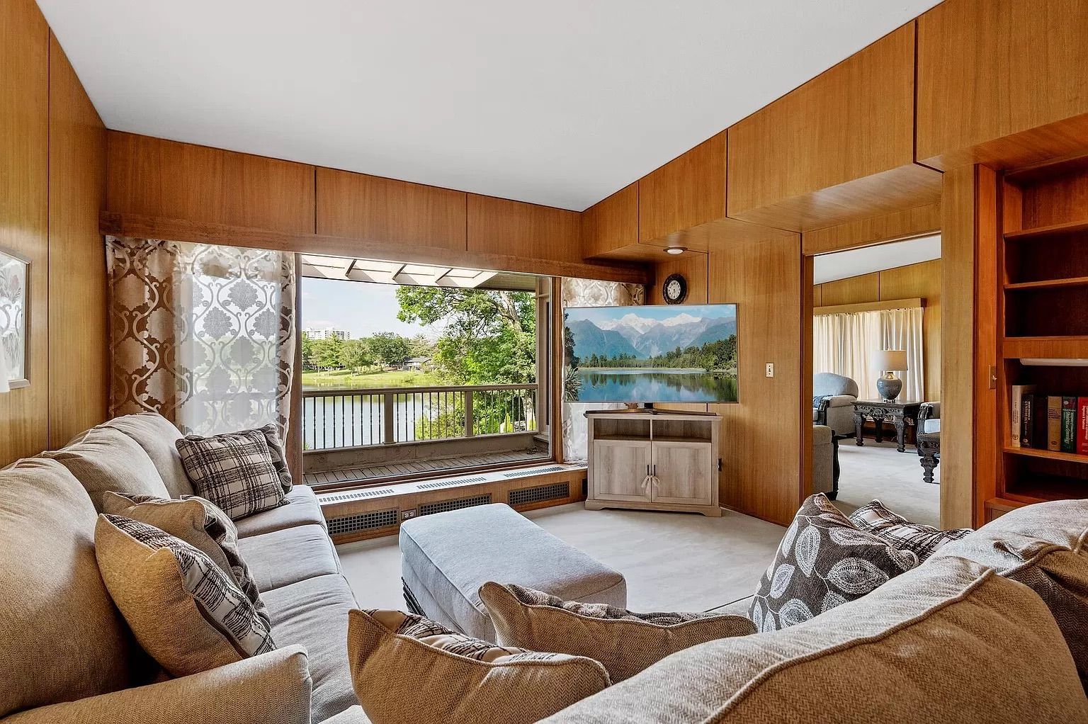 A different living room with wood walls.