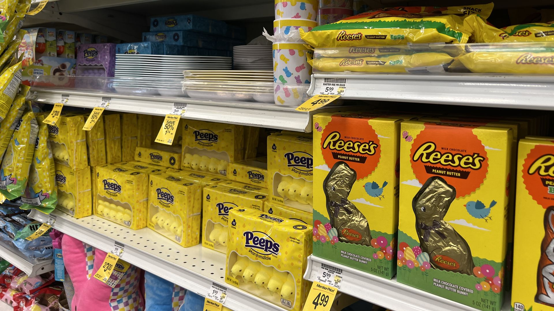 Assortment of Easter candies, including Peeps and Reese's chocolate bunnies, on store shelves.