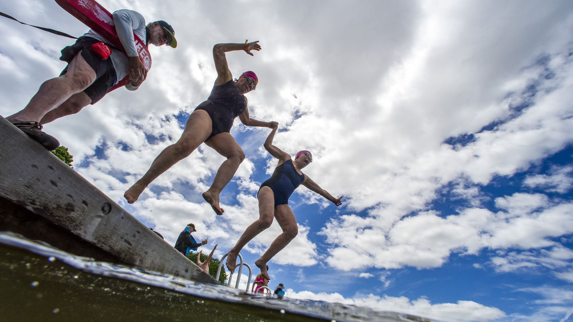 People jump into a river