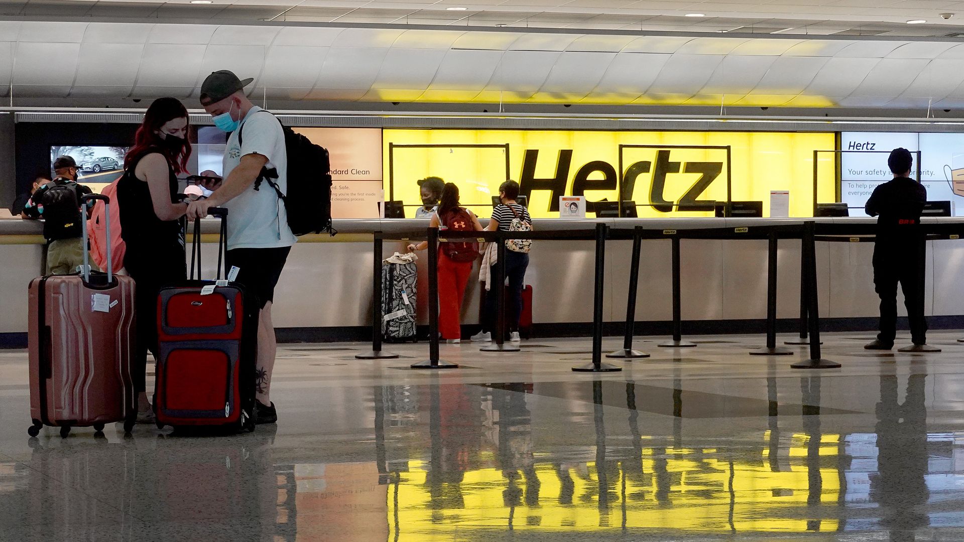 Image of a Hertz airport rental counter. 