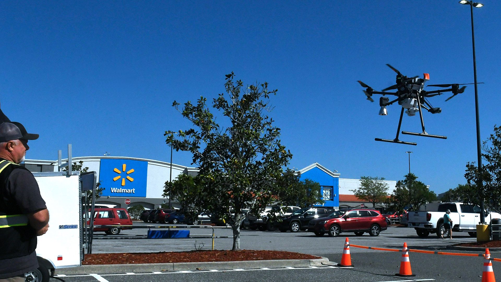 Photo of a delivery drone in the air in front of Walmart.