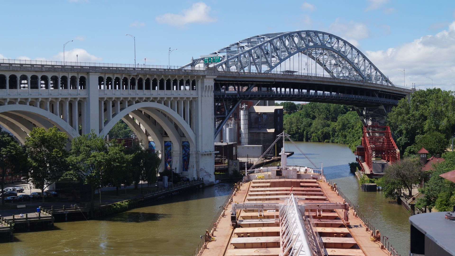 Photo of a freighter navigating the Cuyahoga River, about to go under a bridge
