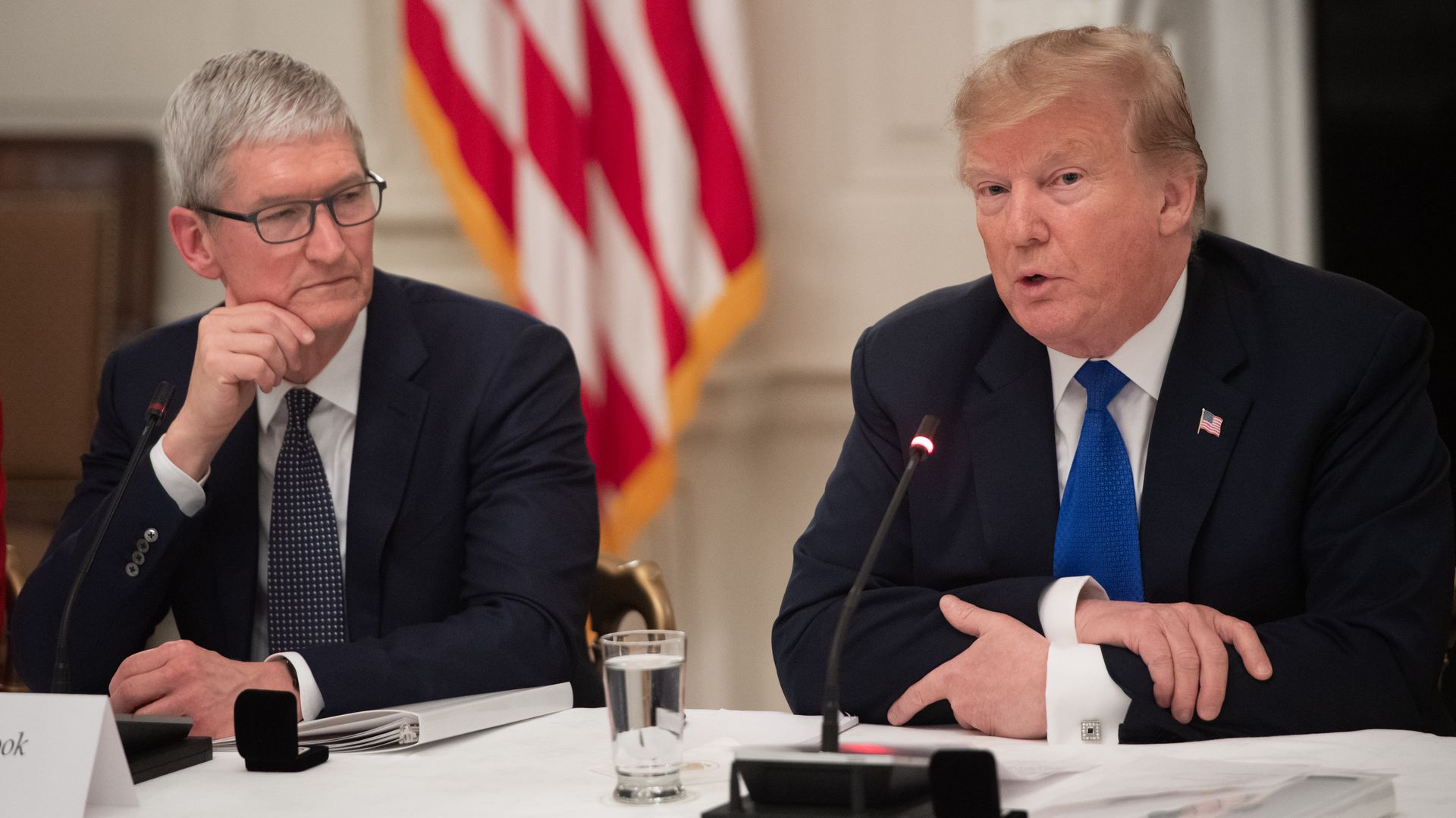 President Donald Trump speaks alongside Apple CEO Tim Cook (L) during the first meeting of the American Workforce Policy Advisory Board