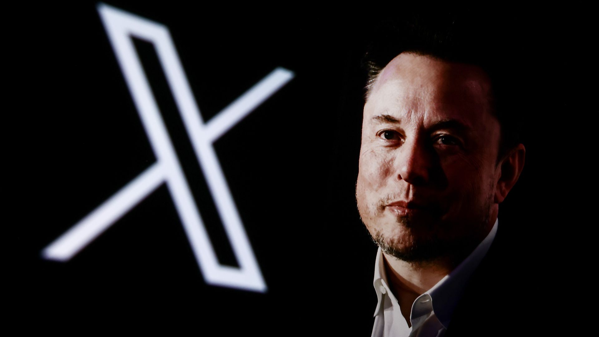 Elon Musk in front of X logo