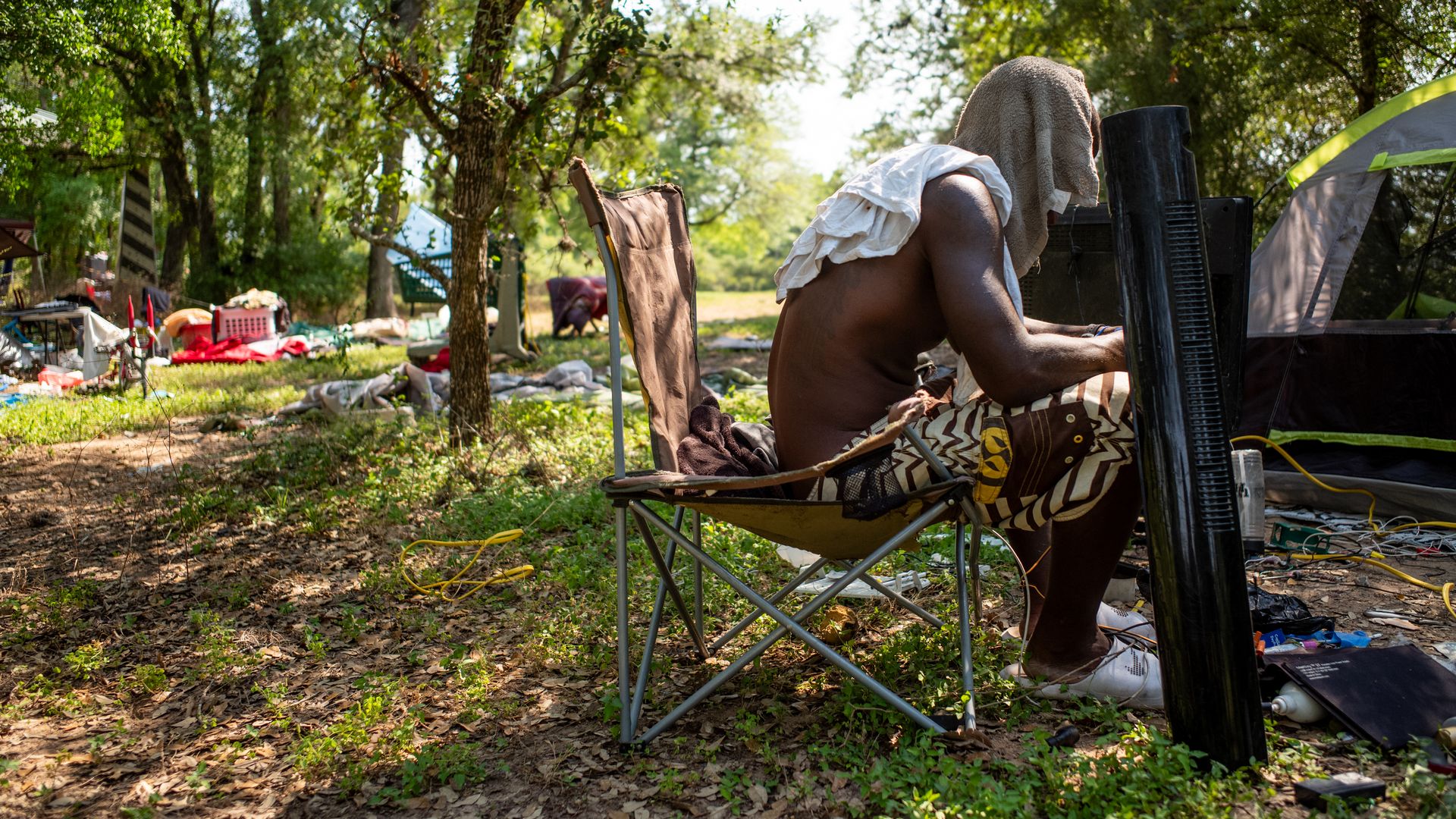  Dymond Black works on an electric fan while sitting in the shade on June 19, 2023 in Austin, Texas. 