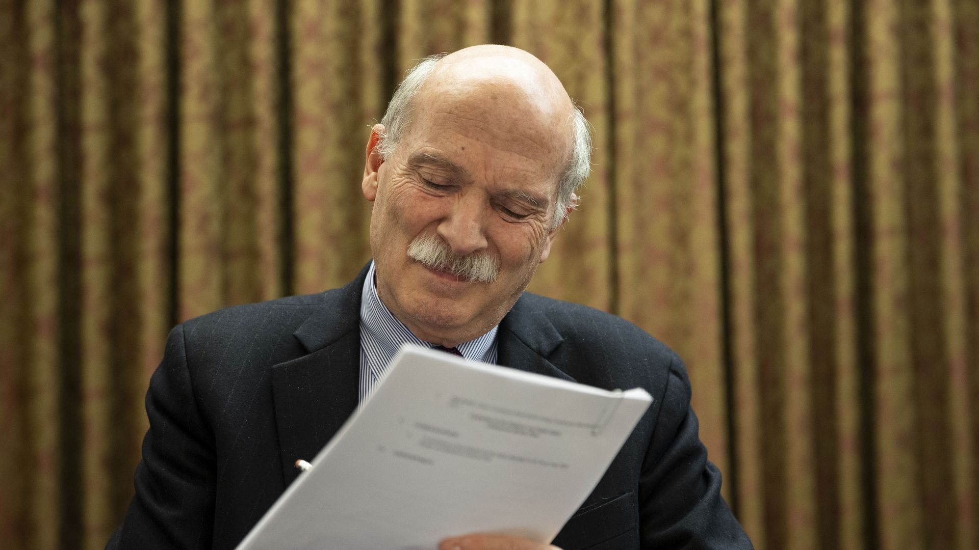 Phil Mendelson is pictured holding a stack of papers