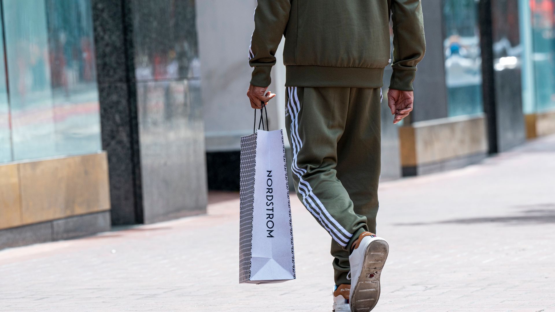 shopper holding a Nordstrom shopping bag