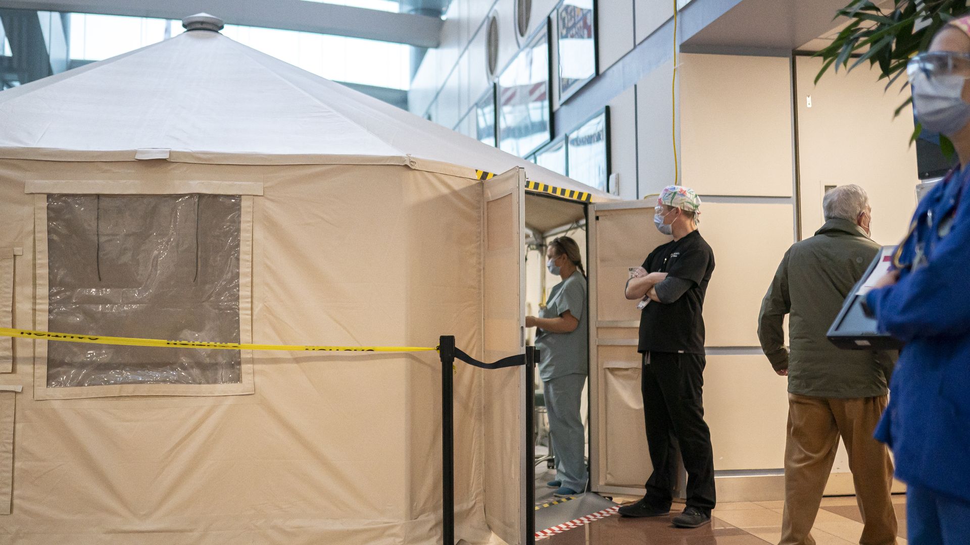 A healthcare worker at the Portland Veterans Affairs Medical Center waits outside a surge tent to receive his COVID-19 vaccination on December 16, 2020 in Portland, Oregon.
