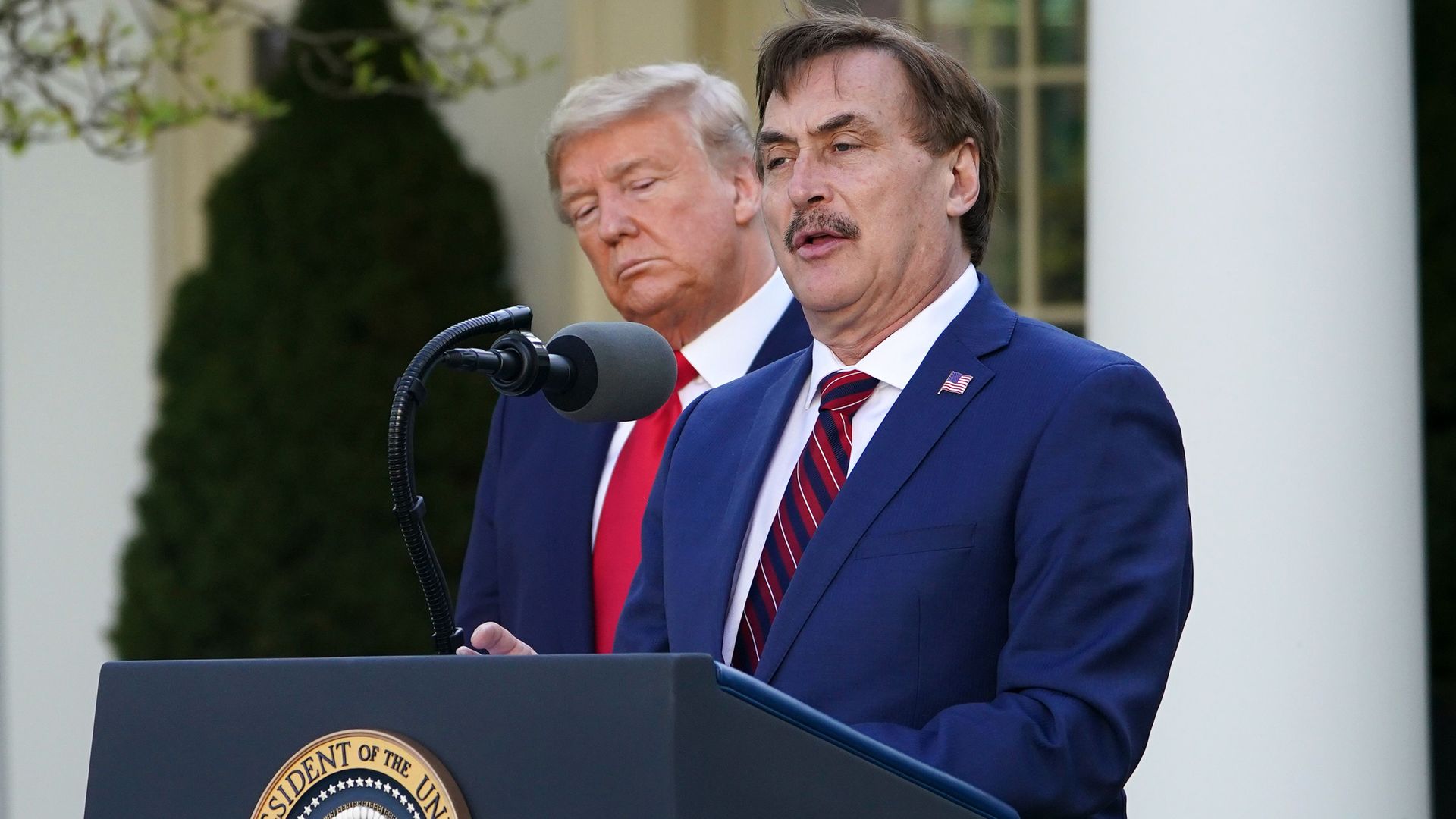 President Donald Trump listens as Michael J. Lindell, CEO of MyPillow Inc., speaks during the daily briefing on COVID-19, at the White House in Washington, DC, on March 30