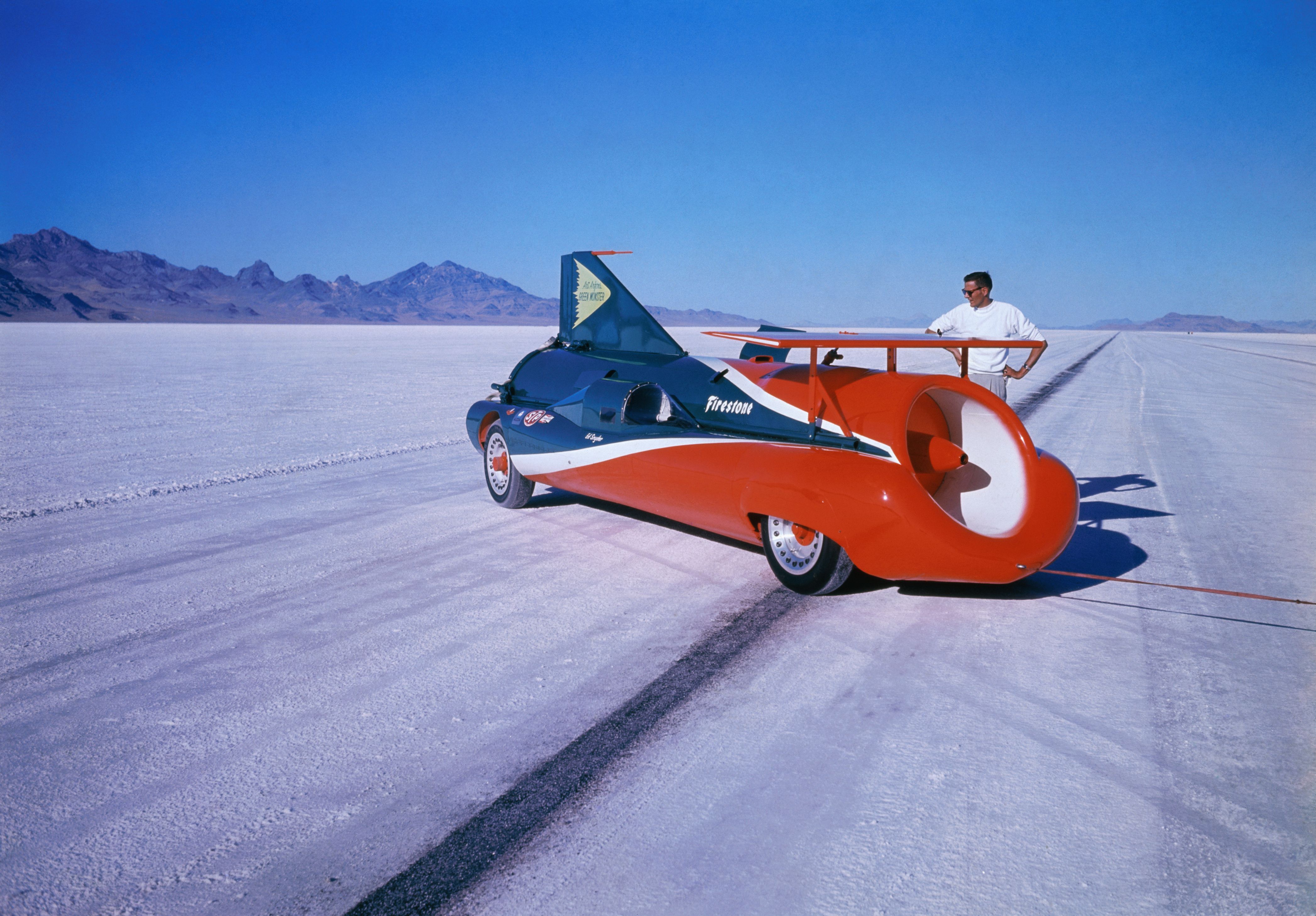 Art Arfons stands next to his jet-powered "Green Monster" car on the salt flats.
