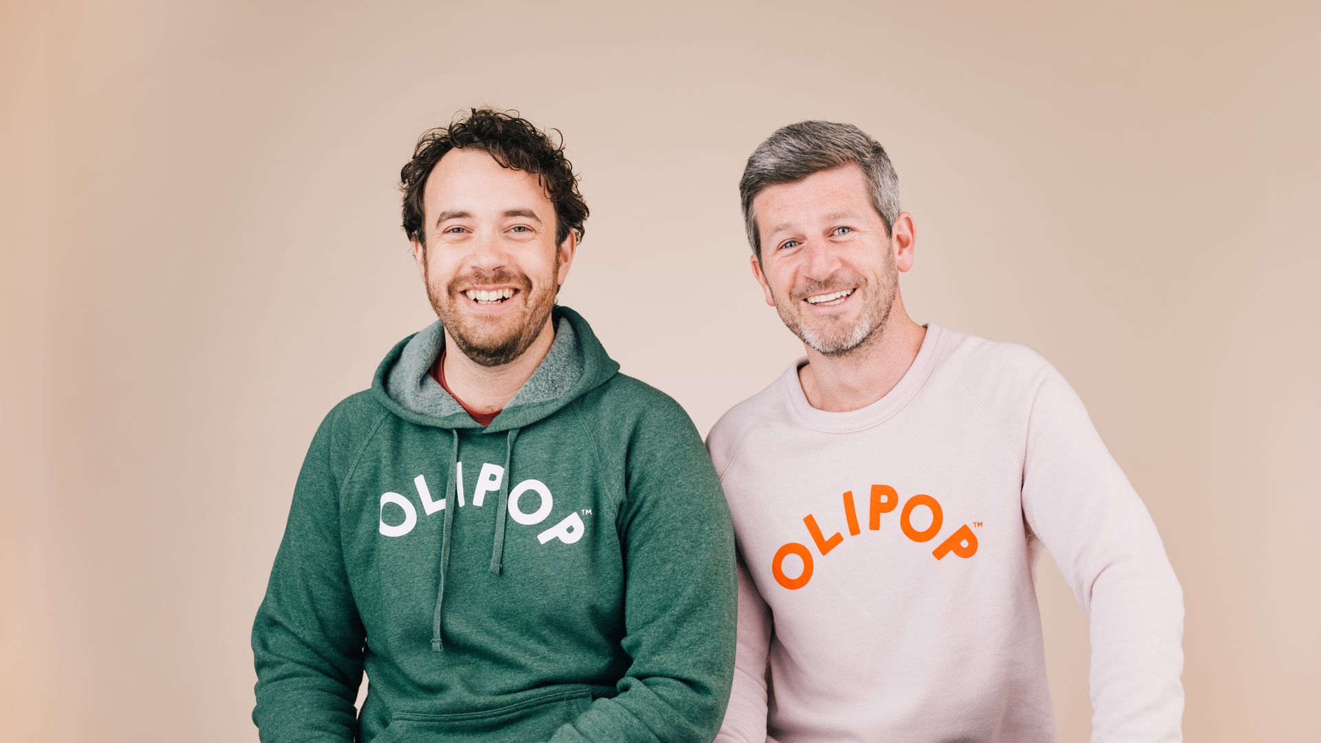 Olipop's founders Ben Goodwin, who is wearing a green hoodie, and David Lester, who is wearing a pink sweatshirt.
