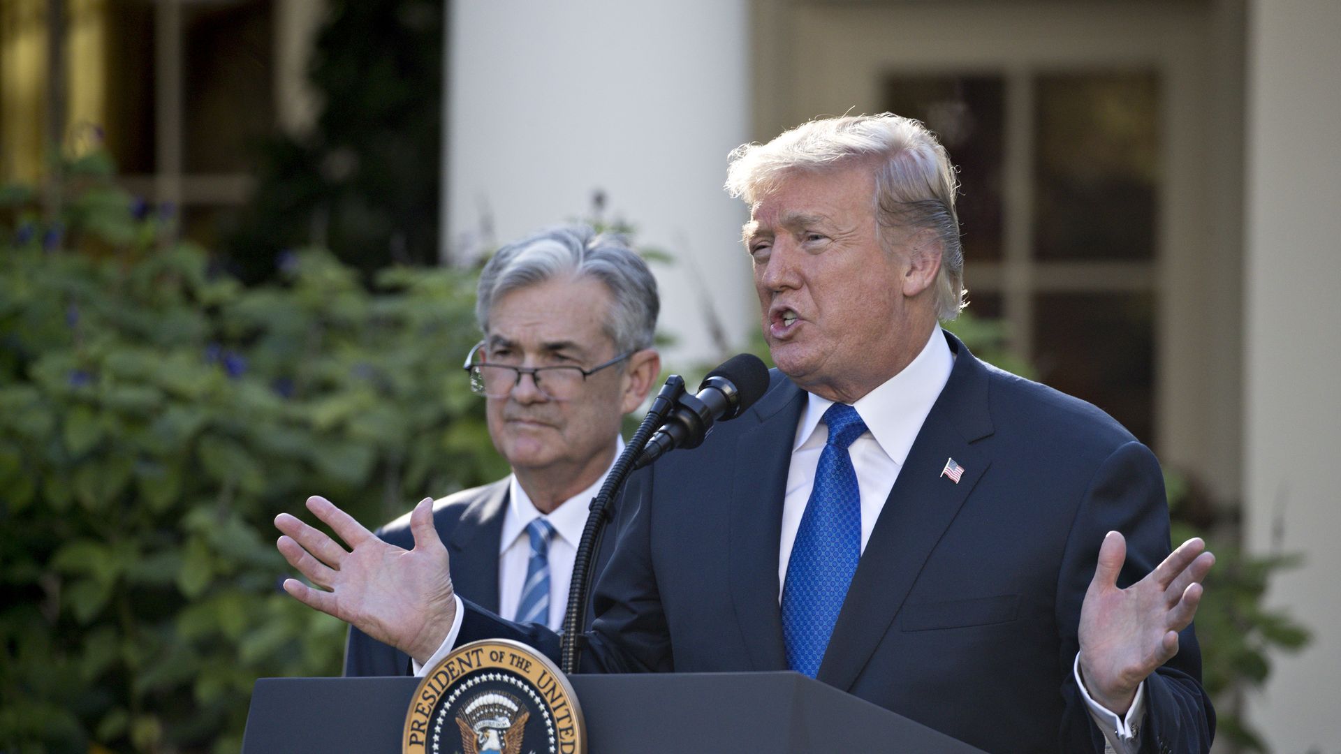 President Trump at a podium, next to Jerome Powell.