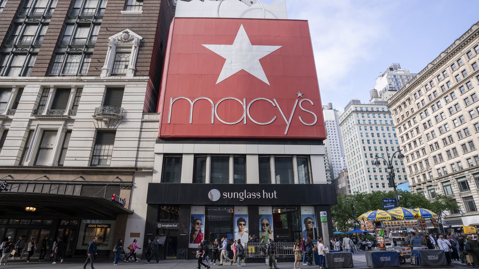People walk in front of the Macy's Herald Square store. 