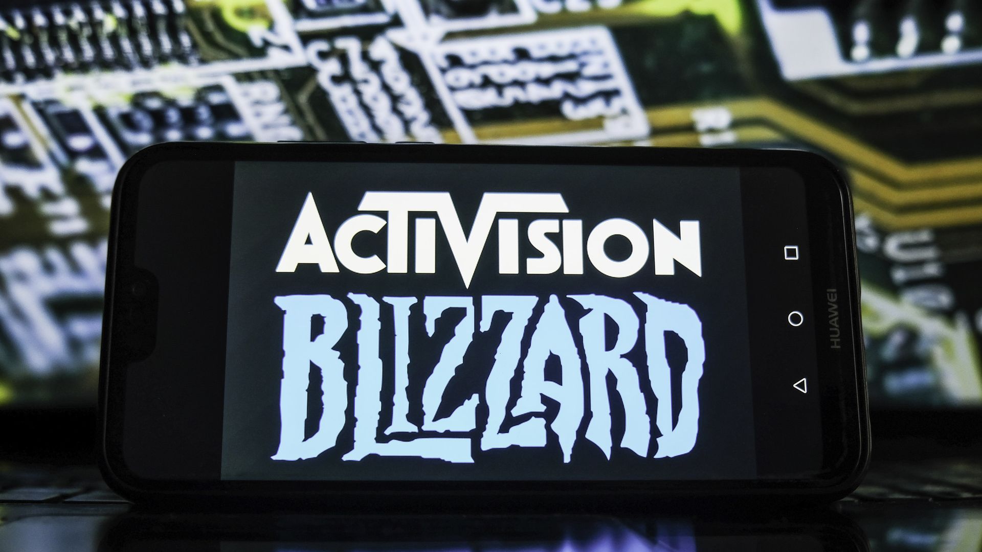 Photo of a phone showing the logos for Activision and Blizzard