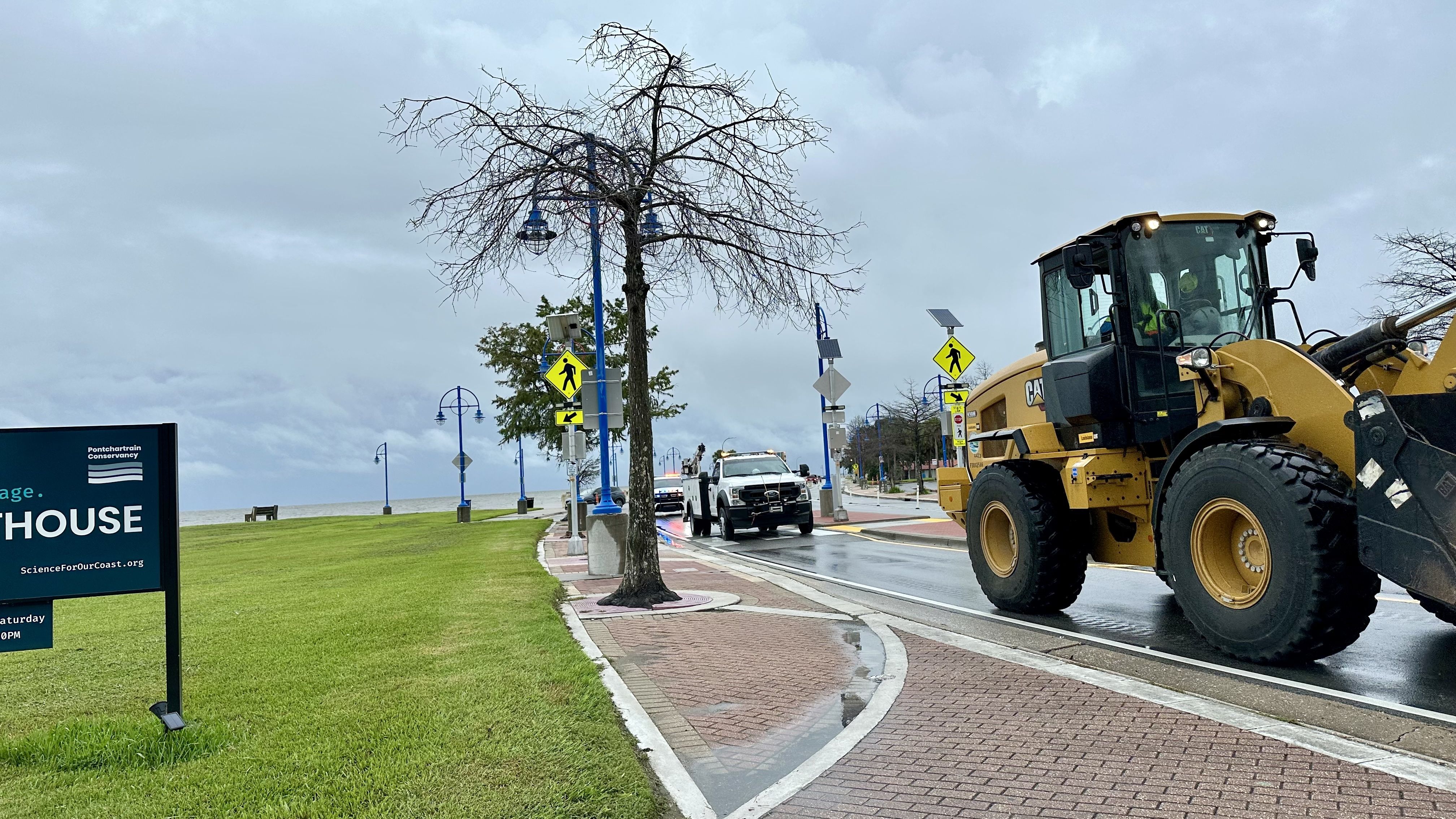 Photo shows heavy equipment by the lakefront.