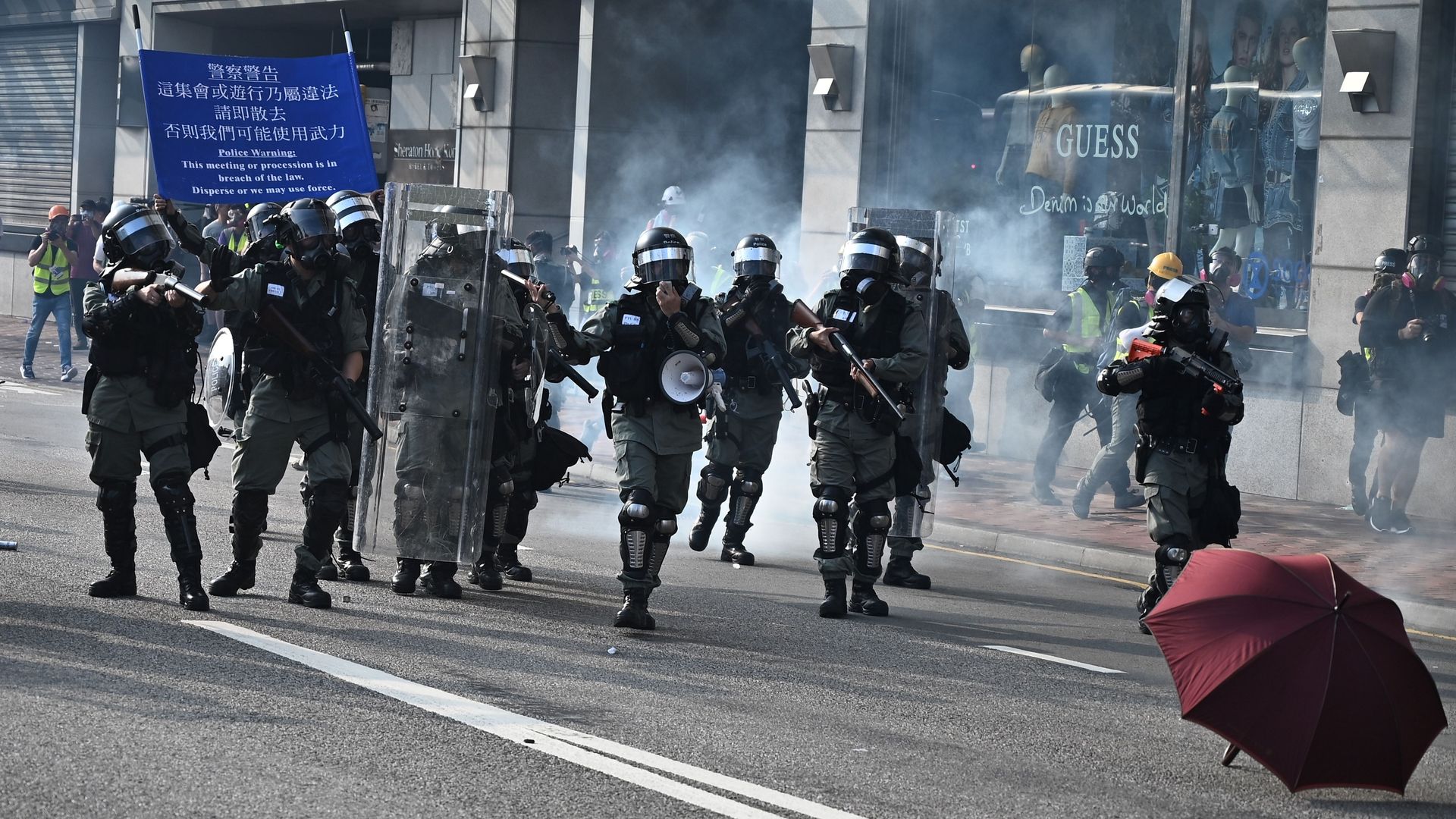 Police fire tear gas during a rally in the Tsim Sha Tsui district in Hong Kong on October 27
