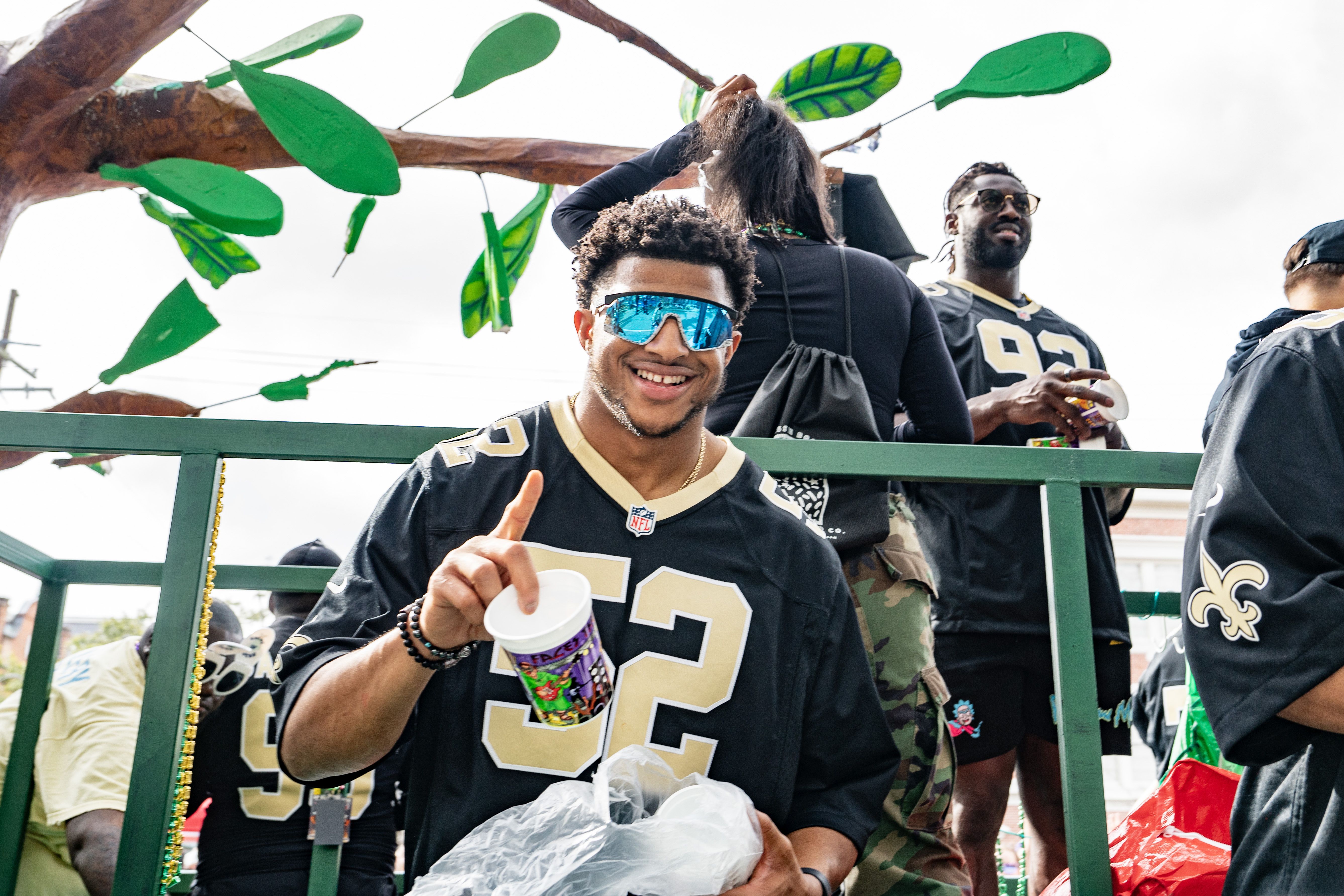 Photo shows D'Marco Jackson wearing a Saints jersey on a float.