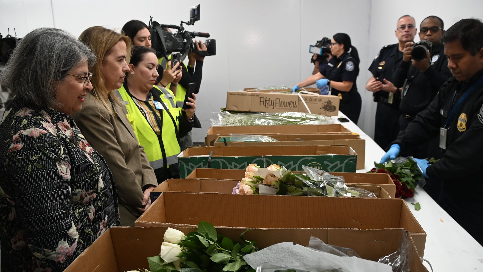 Miami-Dade Mayor Daniella Levine Cava watches how airport workers inspect imported flowers delivered ahead of Mother's Day.