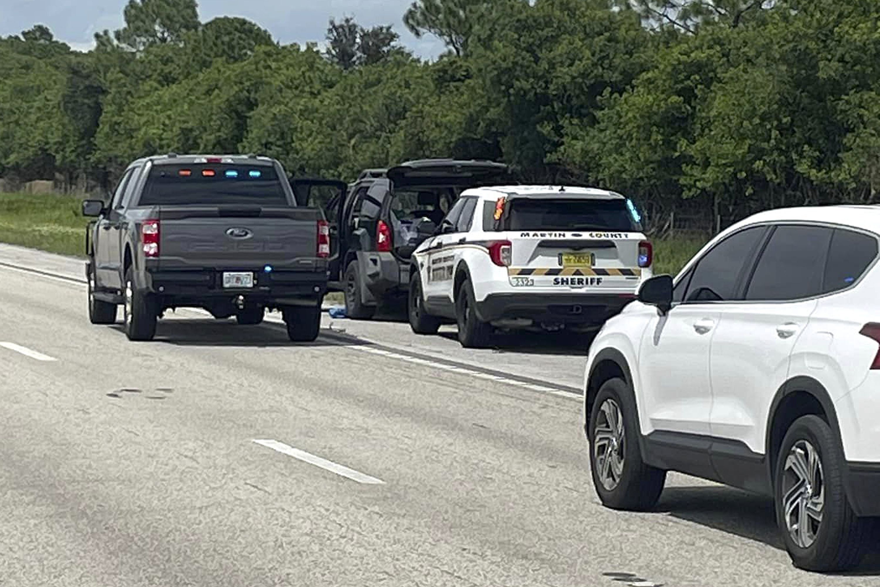 This photo provided by the Martin County Sheriff's Office shows Sheriff's vehicles surrounding an SUV on the northbound I-95 in Martin County on Sunday, Sept. 15, 2024.