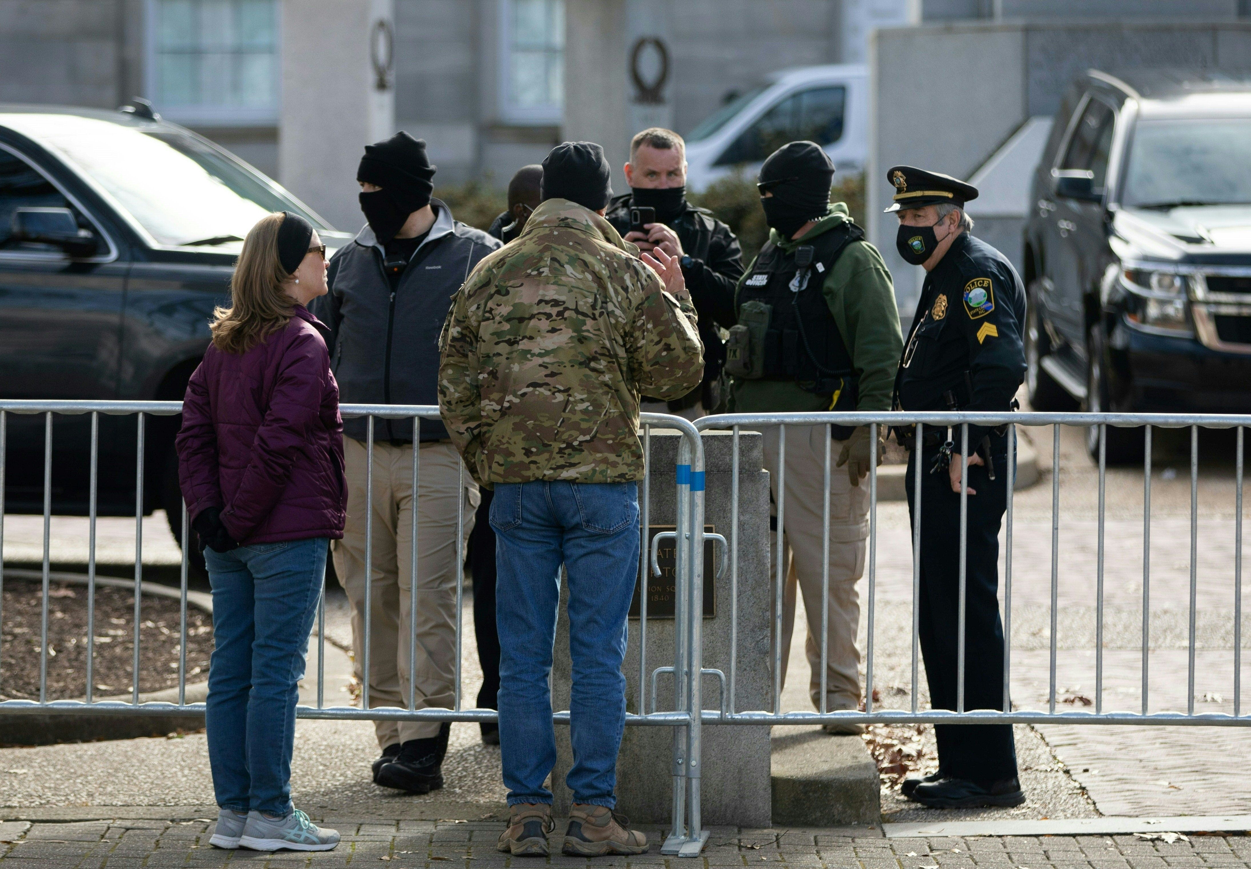 A man has a conversation with law enforcement in front of the state capitol building in downtown Raleigh, North Carolina, on January 17