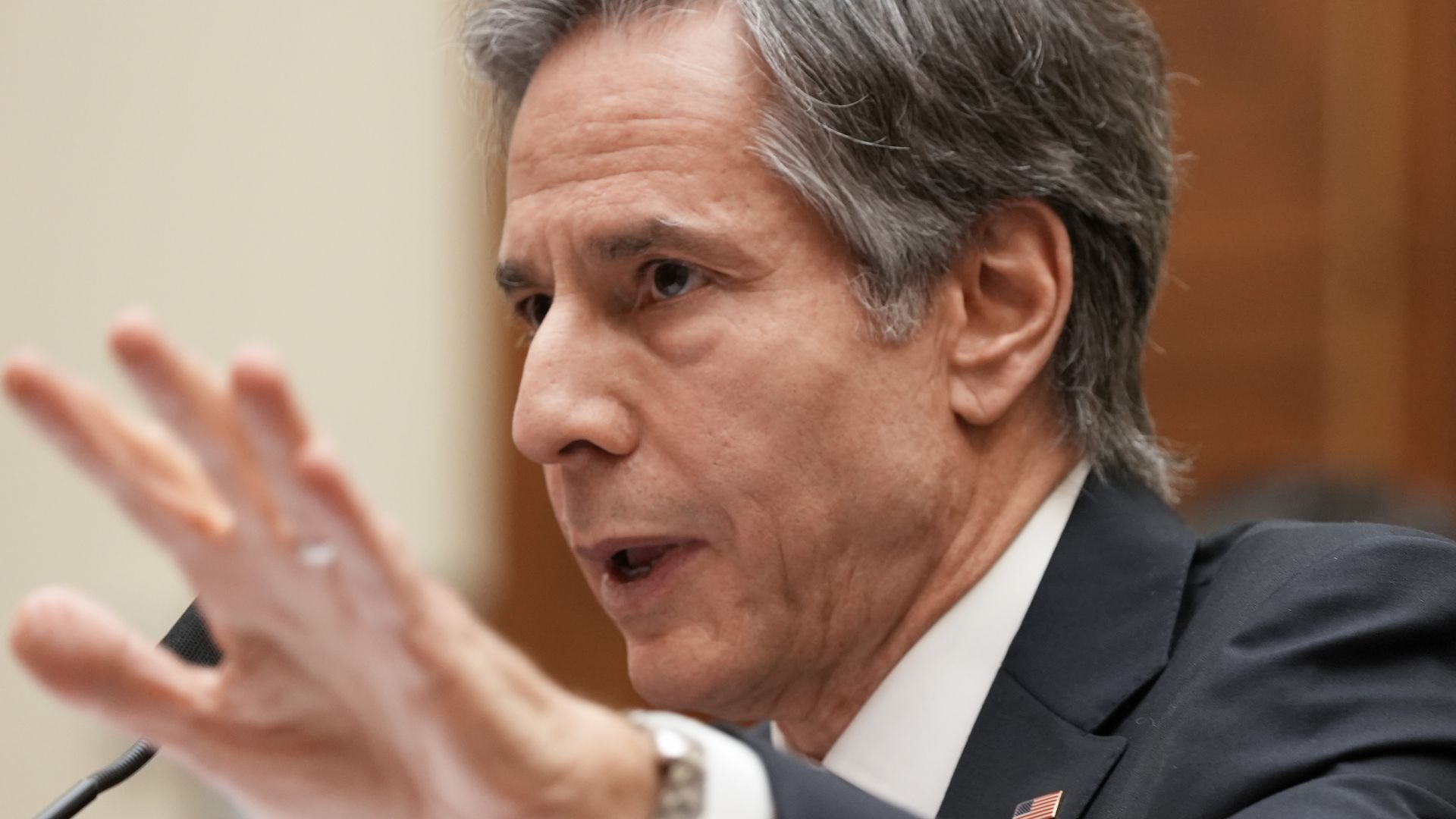 Tony Blinken speaks with his hand outstretched